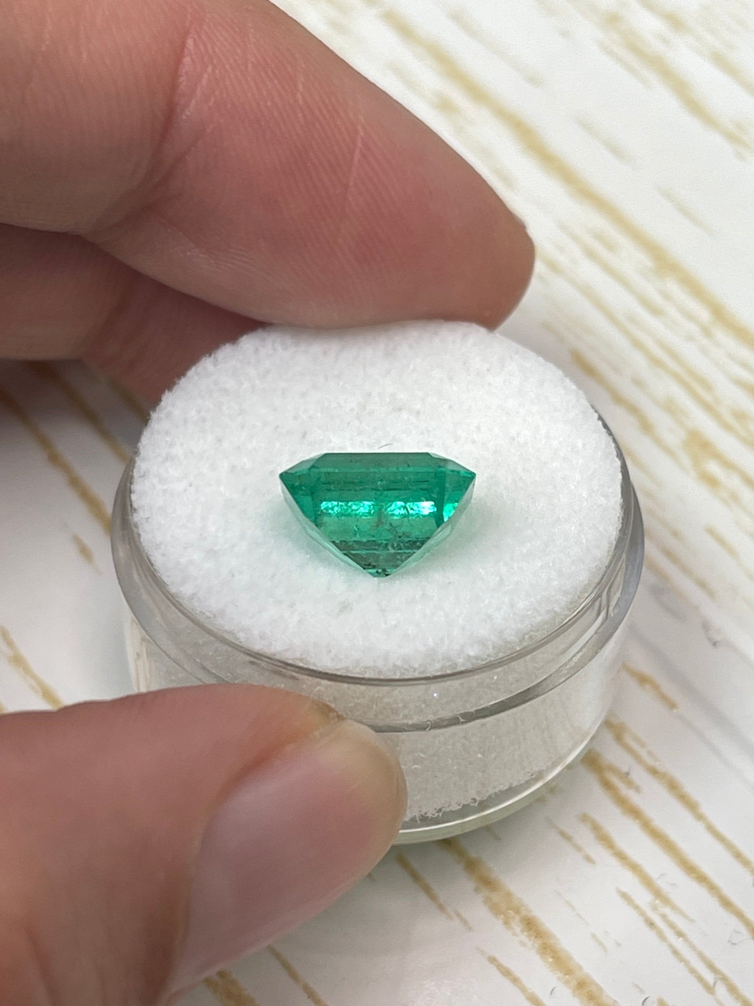 Vibrant 4.33 carat Colombian emerald Asscher cut loose gemstone displayed by JR Colombian Emeralds.