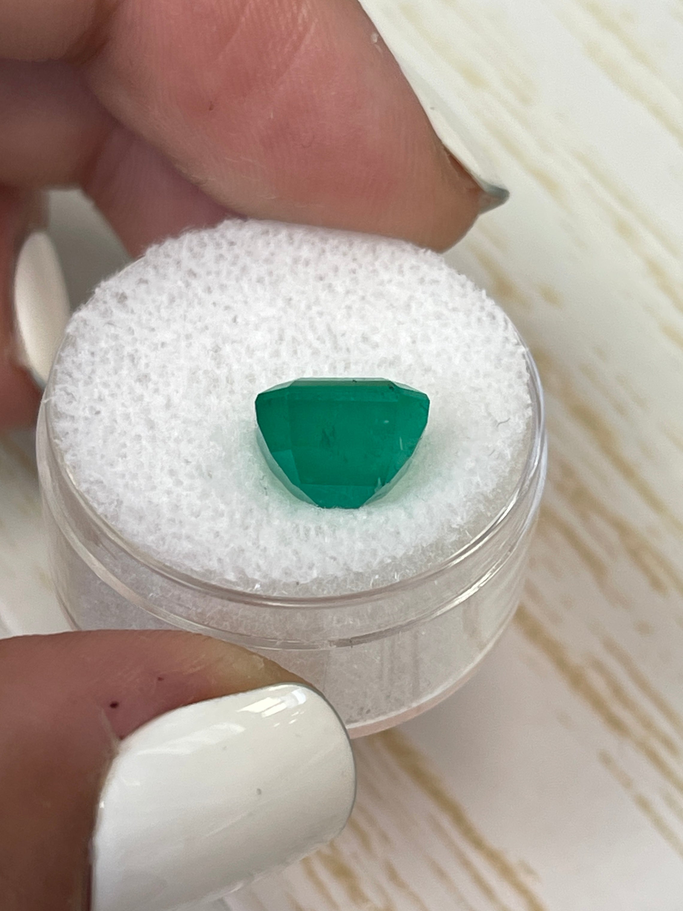 Forest green Colombian emerald Asscher cut, 4.34 carats, from JR Colombian Emeralds, showing the gemstone's vibrant color and facets.