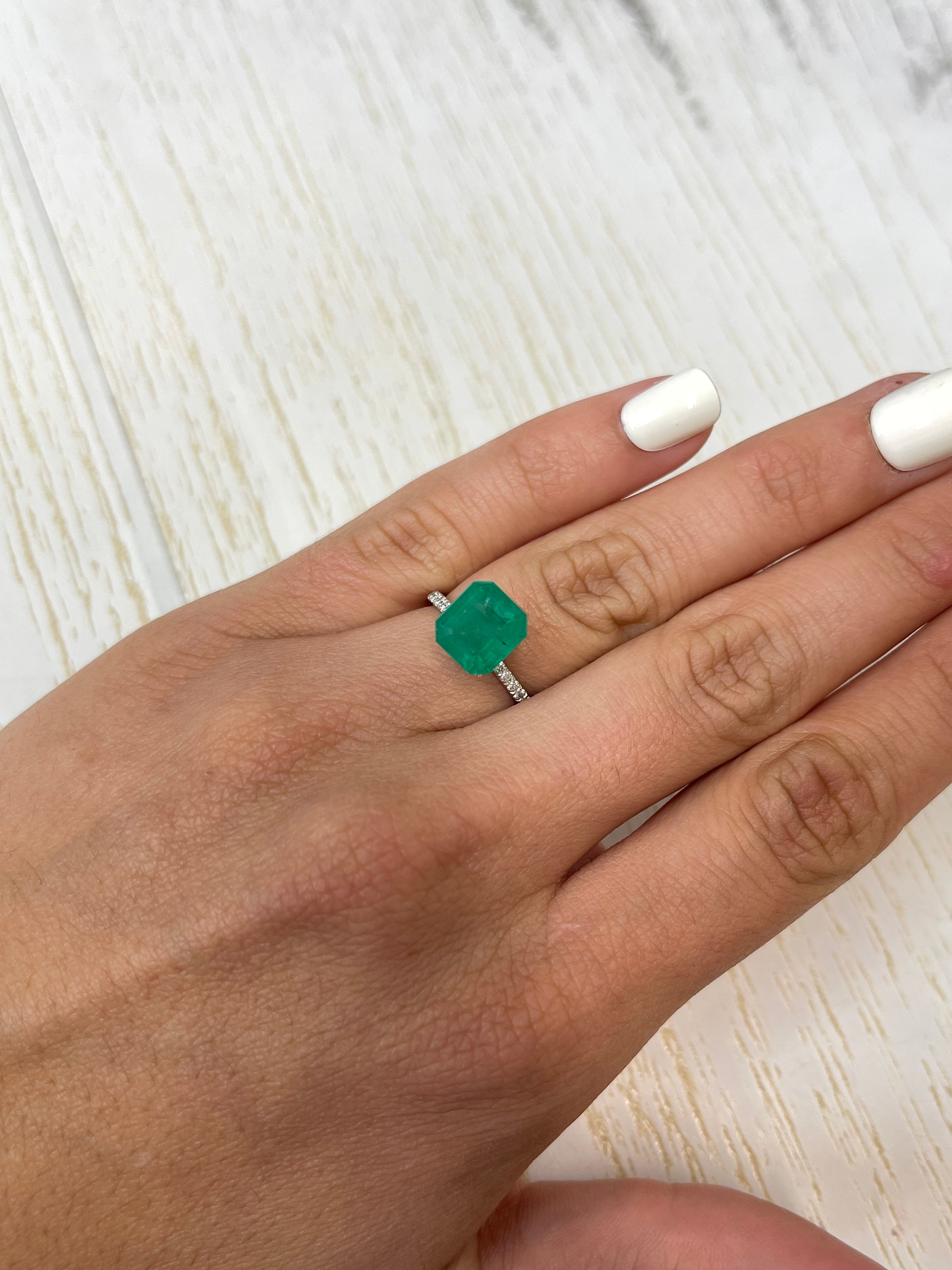 Forest green Colombian emerald Asscher cut, 4.34 carats, 9.5x9mm from JR Colombian Emeralds, showcasing vibrant color and clarity.