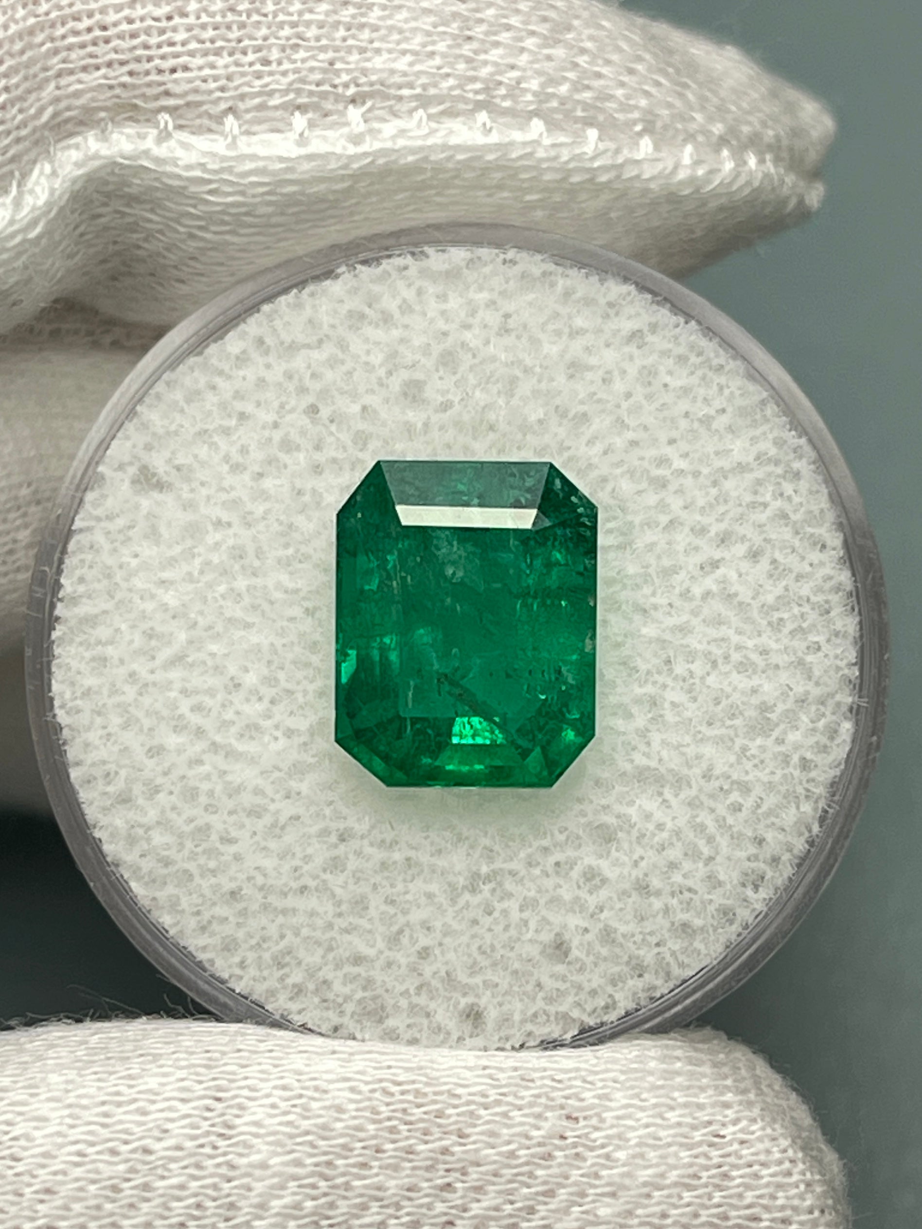 Deep green 4.36 carat natural Zambian emerald cut loose gemstone from JR Colombian Emeralds, showing its vibrant color and clarity.