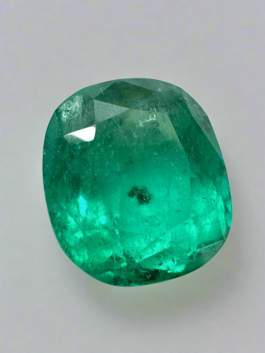 Deep green 4.37 carat Colombian emerald loose cushion cut gem with natural freckles, from JR Colombian Emeralds.