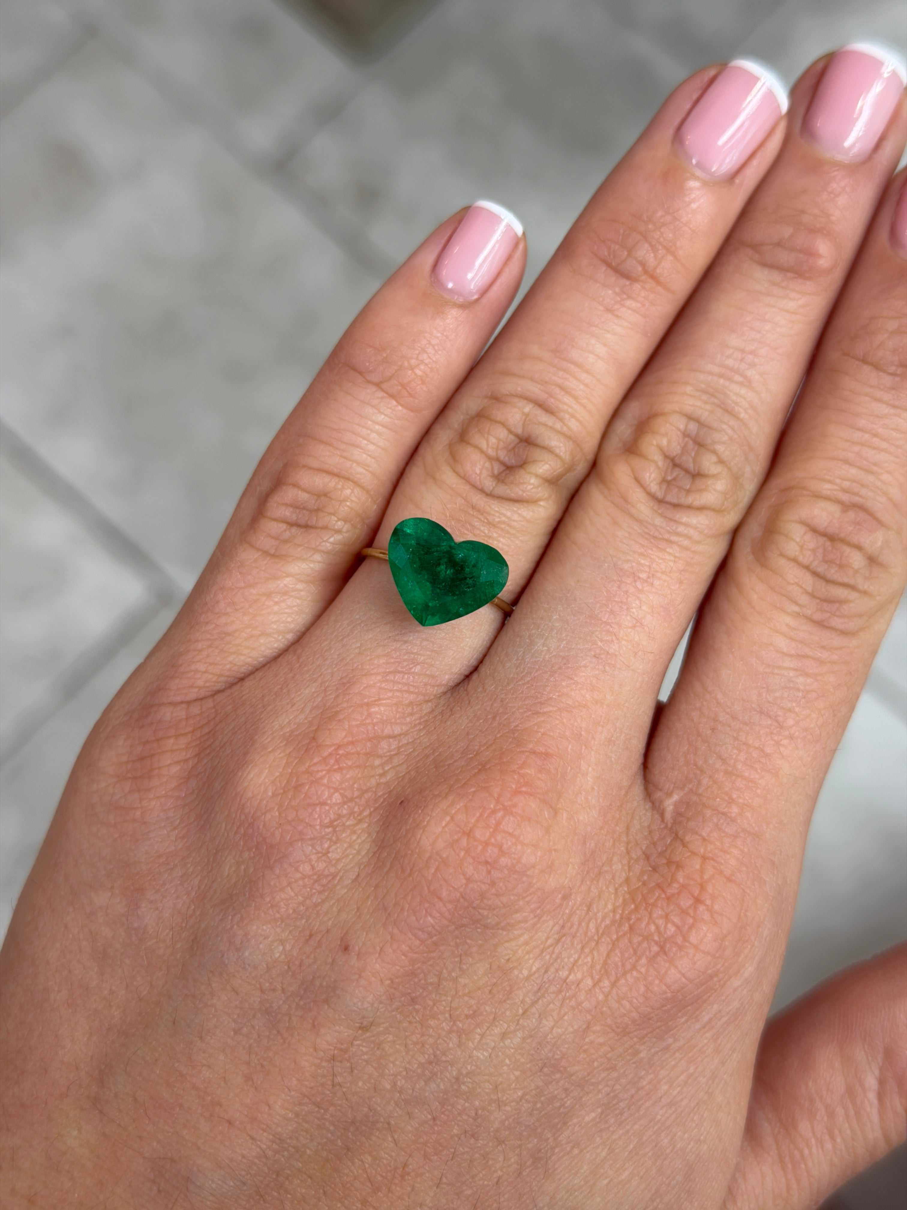 4.46 carat AAA+ intense green natural Colombian emerald heart-cut loose gemstone displayed for jewelry making.