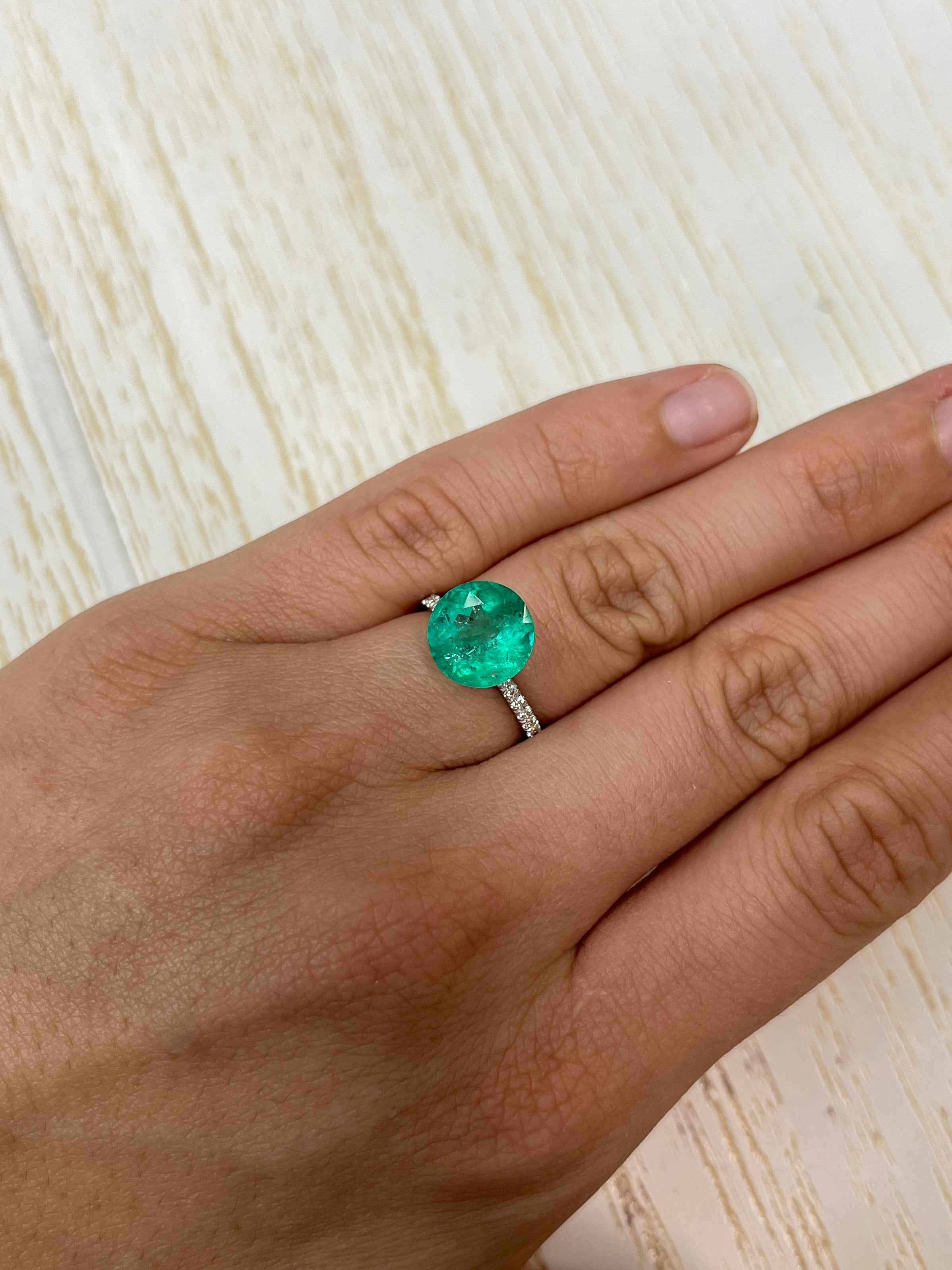 4.50 carat bluish green round loose Colombian emerald from JR Colombian Emeralds, natural gemstone with vibrant color and clarity.