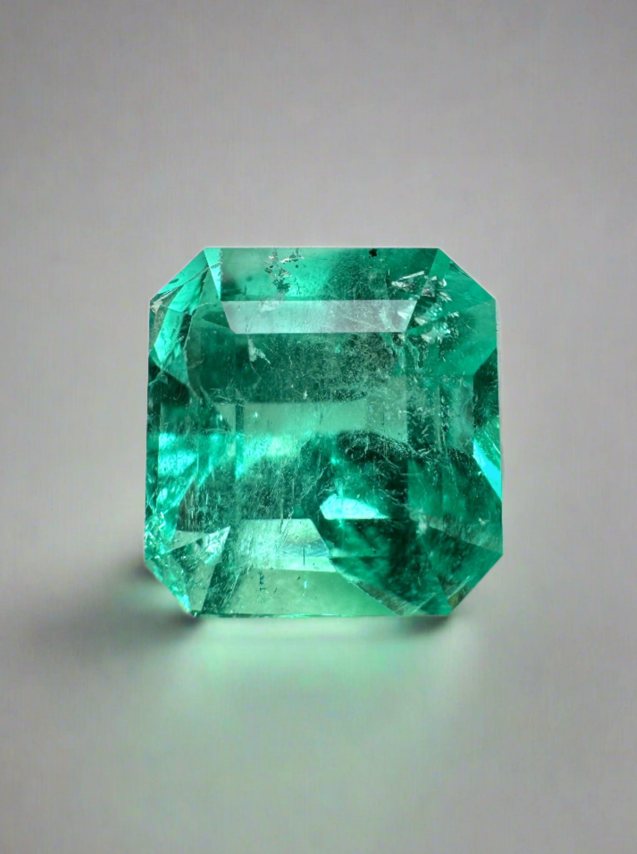 Vibrant 4.53 carat loose Colombian emerald Asscher cut gemstone with rich green color and high clarity.
