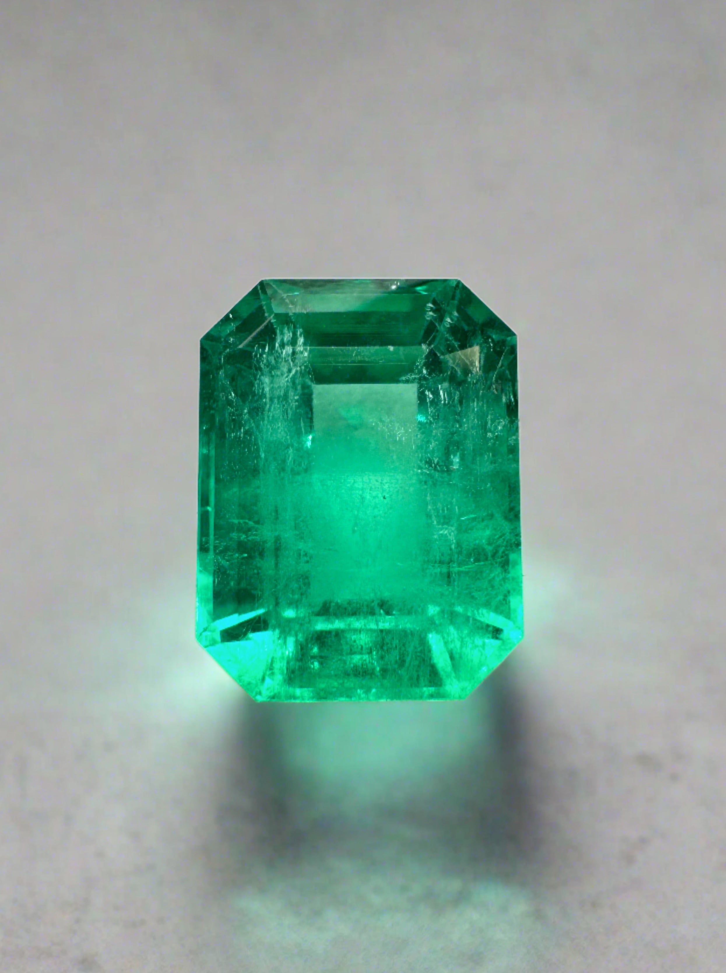 Vivid 4.53 Carat Muzo green Colombian emerald loose gemstone in an emerald cut, showcasing vibrant natural color and clarity.