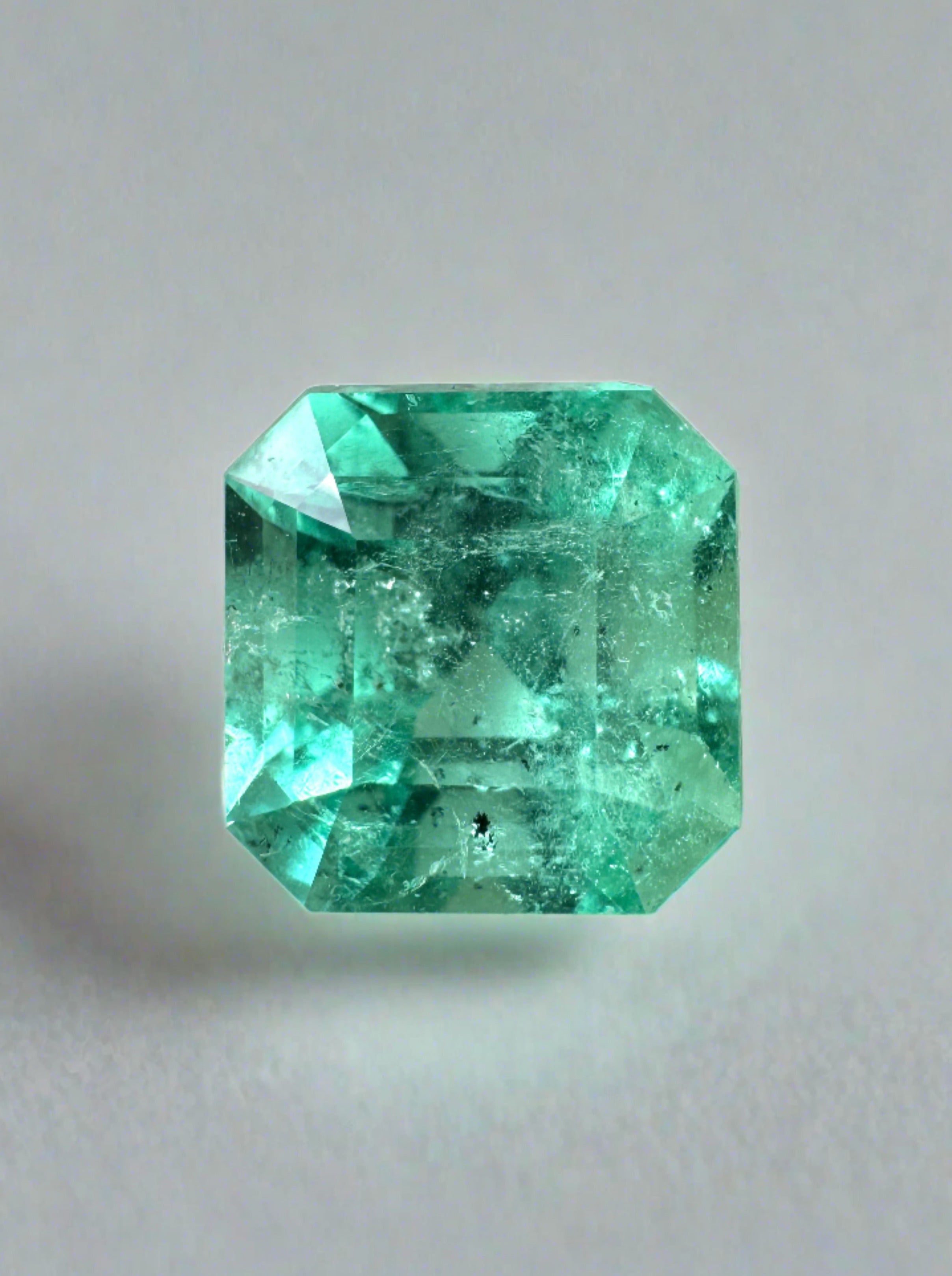 4.69 carat loose Colombian emerald with Asscher cut, freckled surface, 10x10mm size, featuring clipped corners, by JR Colombian Emeralds