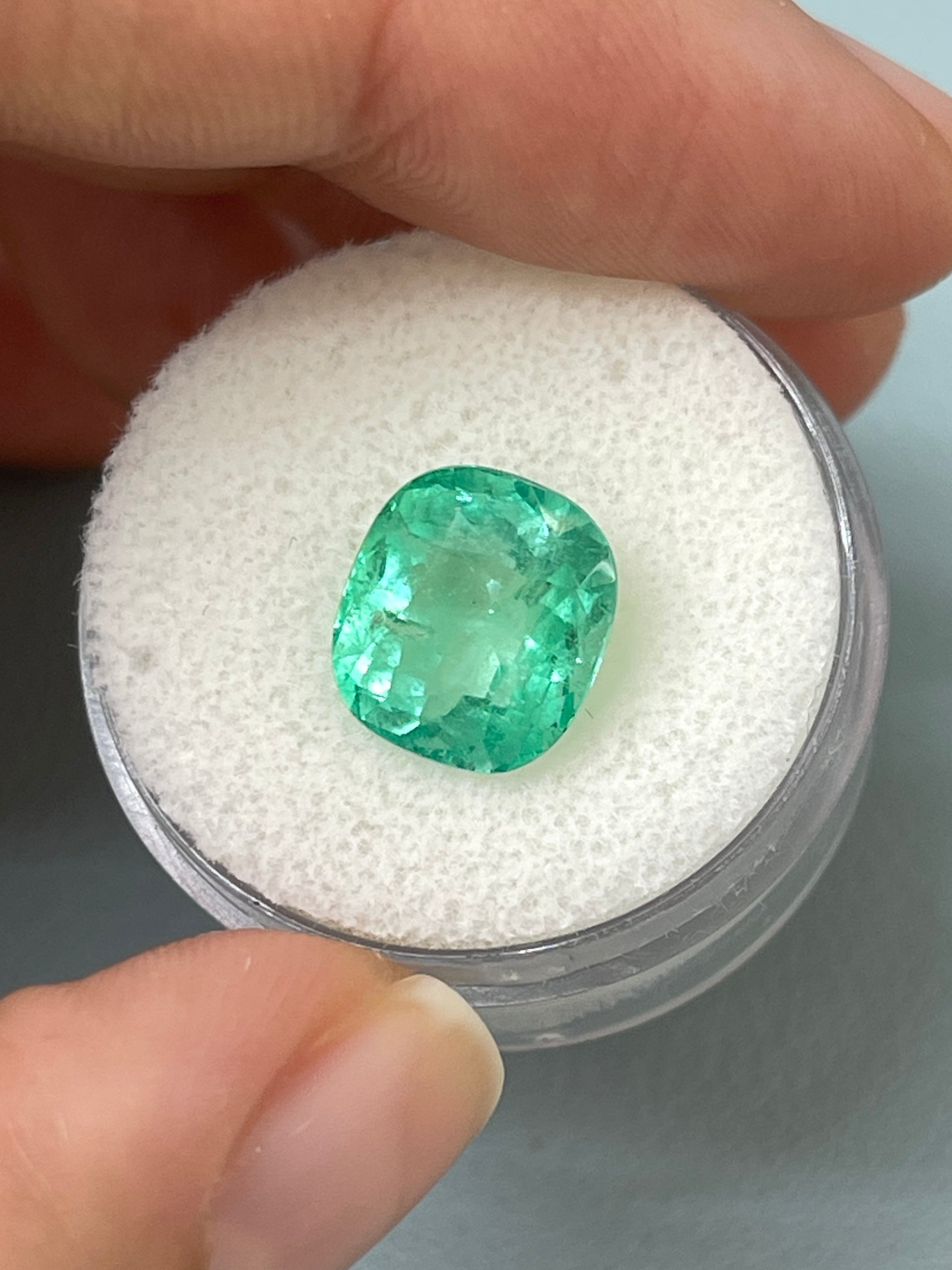 Light green 4.71 carat Colombian emerald in cushion cut, natural loose gemstone with vibrant gemmy appearance.