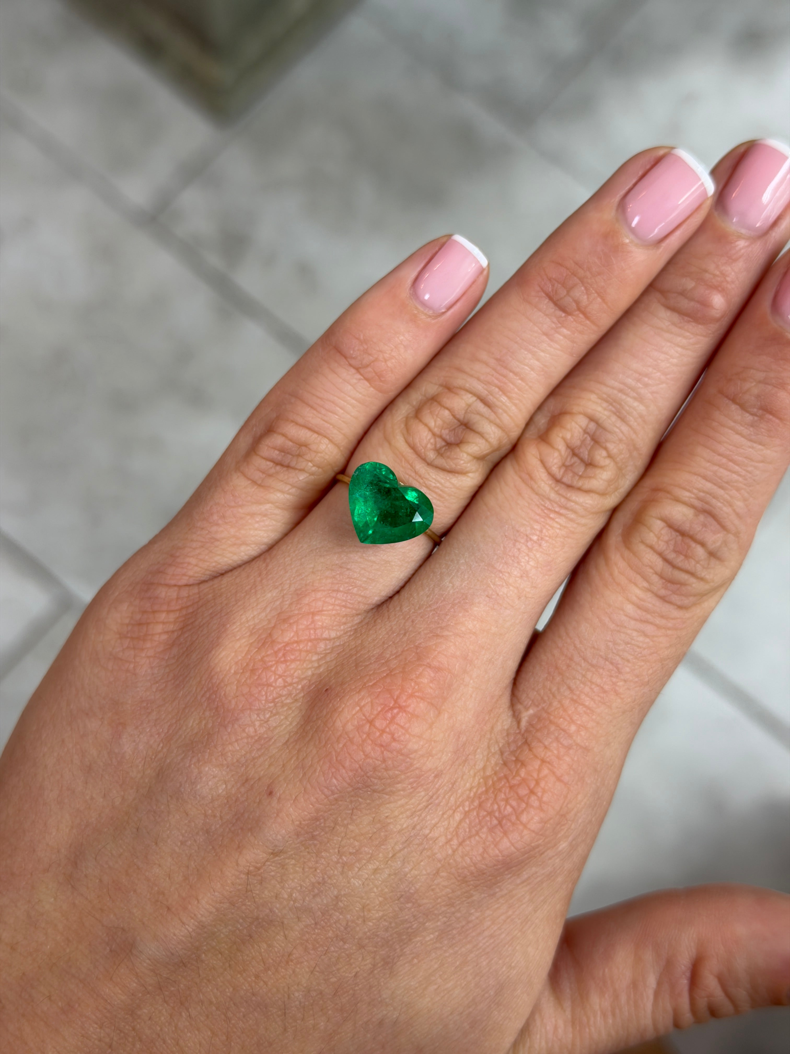 4.79 carat AAA+ intense green Colombian emerald loose gemstone in heart cut, natural and vibrant with vivid green color.