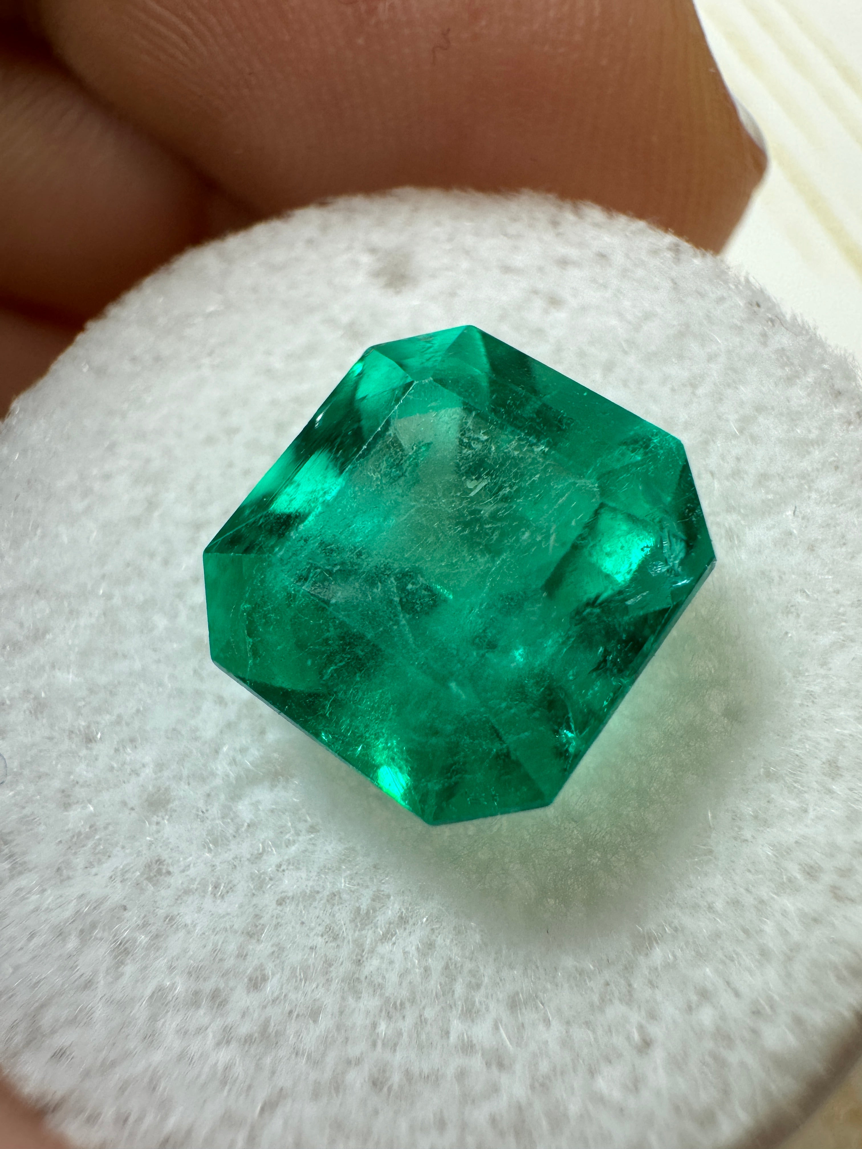 4.83 carat bluish Colombian emerald loose gemstone in Asscher cut, displayed on a white background.
