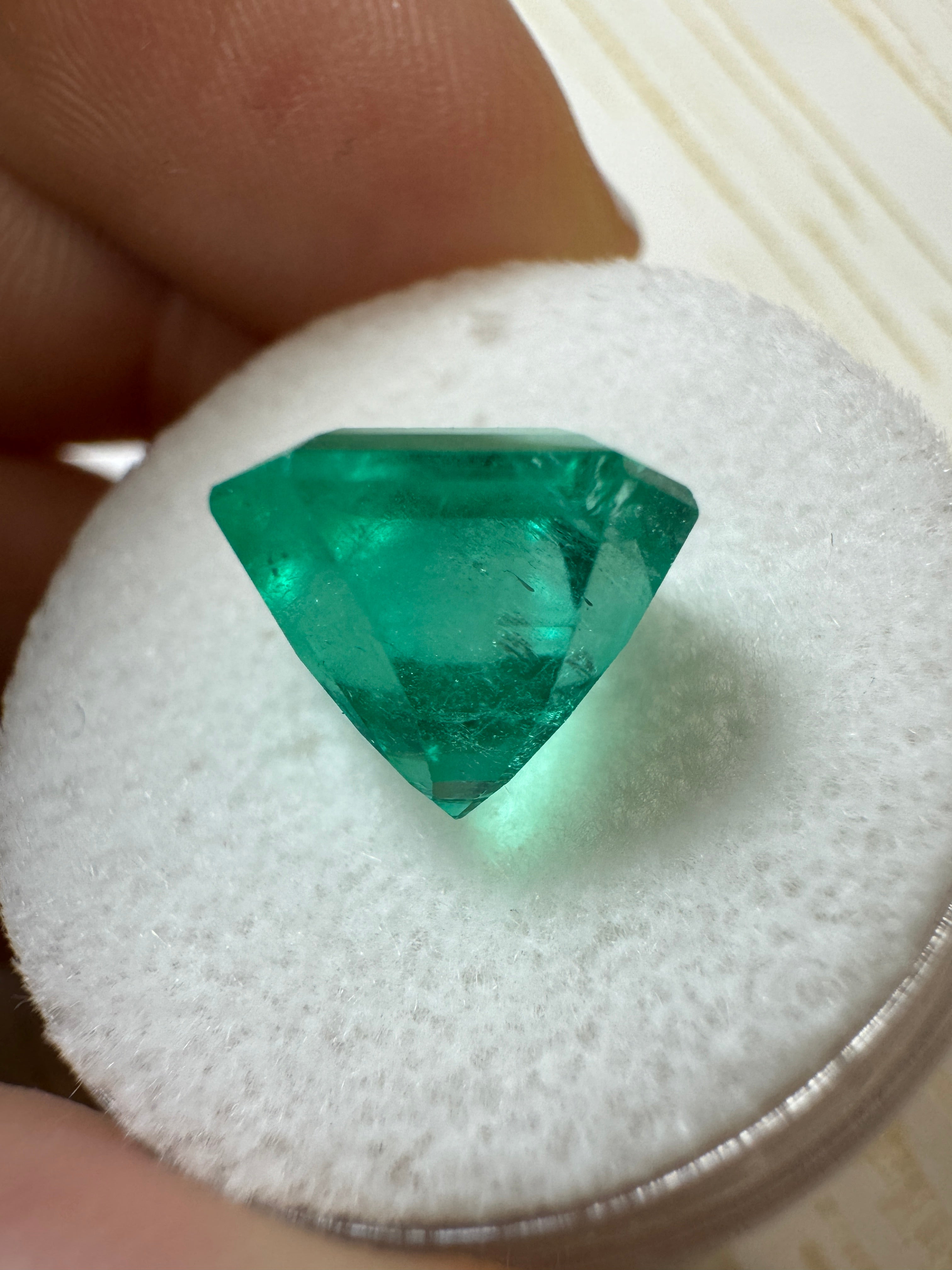 Loose 4.83 carat bluish Colombian emerald in 10x10mm Asscher cut, showcasing vibrant green-blue hues and clarity.