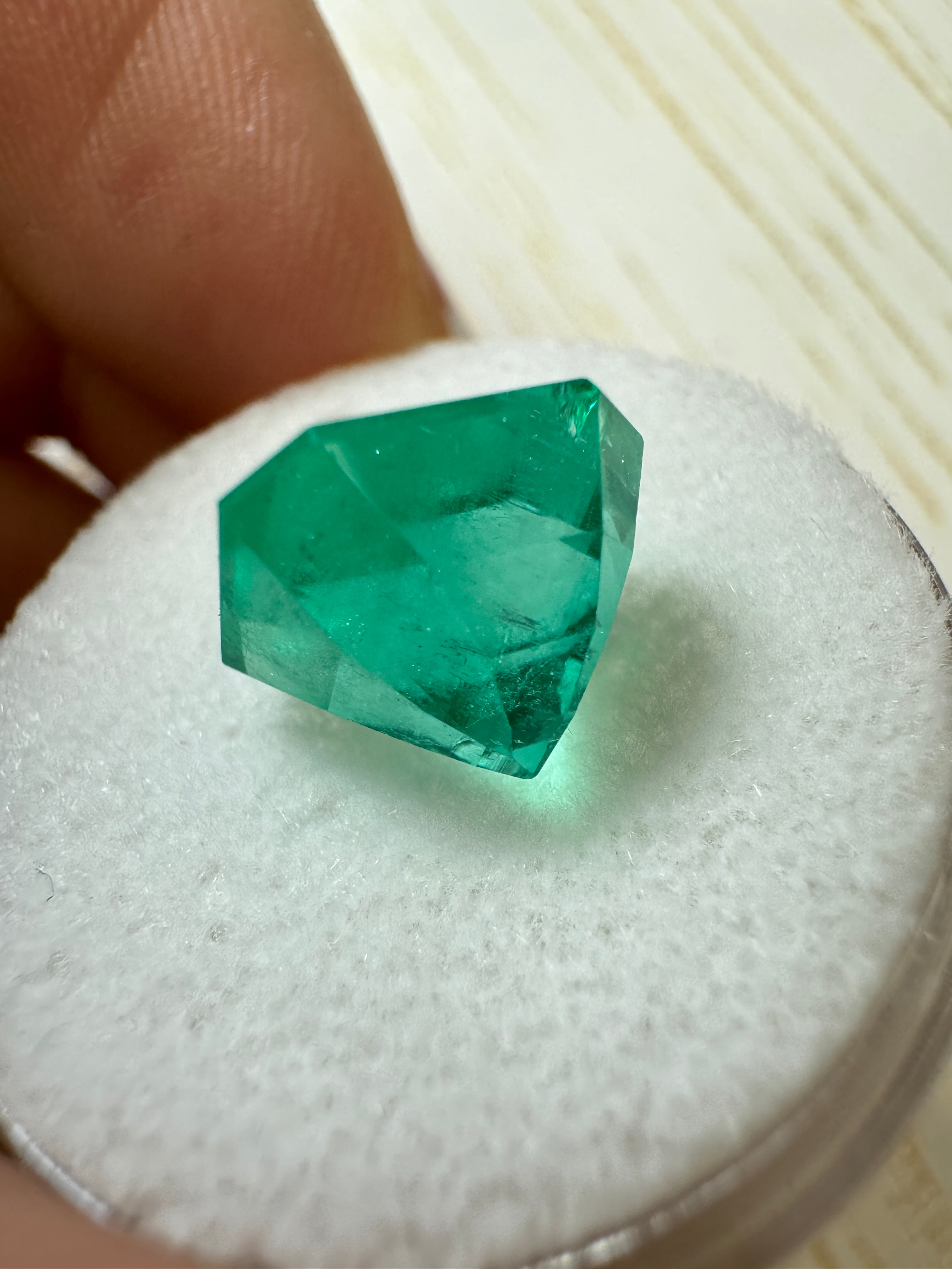 4.83 carat bluish Colombian emerald loose Asscher cut gemstone from JR Colombian Emeralds, showcasing deep blue-green color and facets.