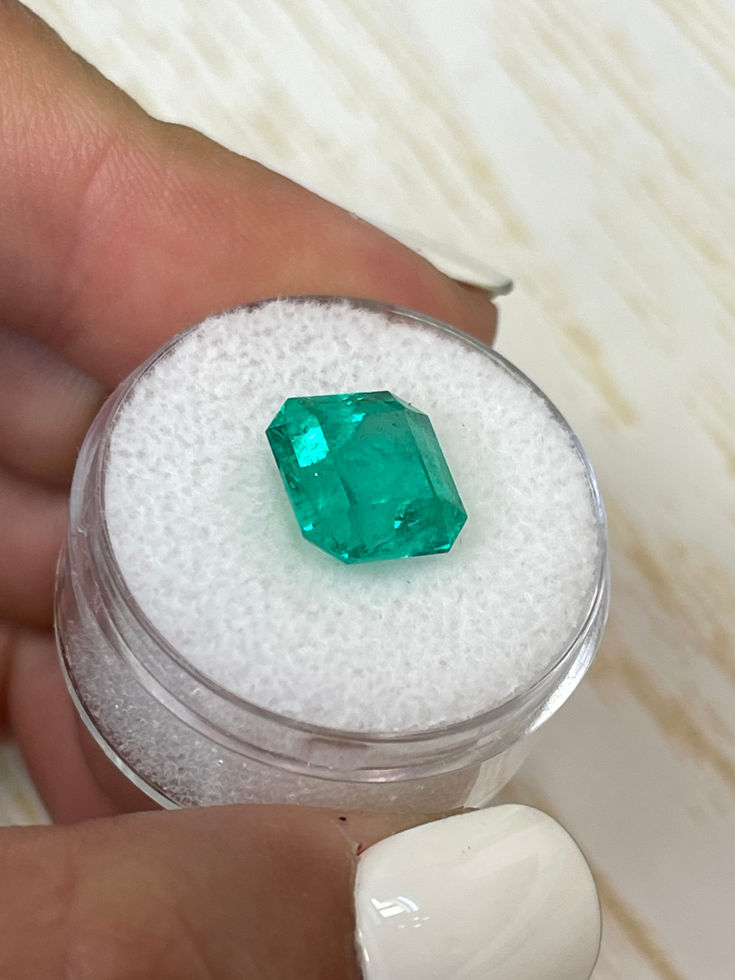 Vibrant 4.83 carat loose Colombian emerald in an Asscher cut, showcasing rich green color and clarity, from JR Colombian Emeralds.