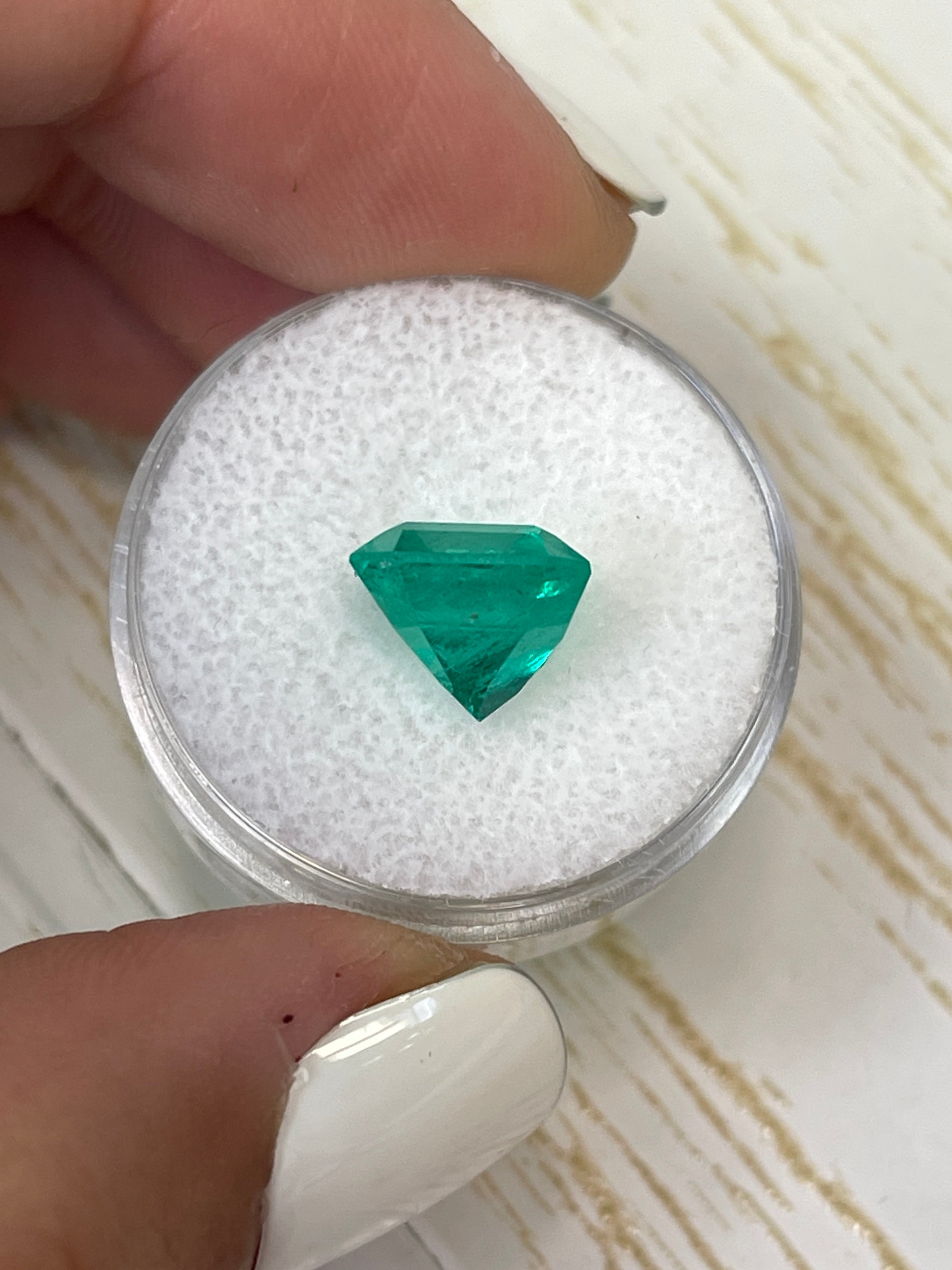 Vibrant 4.83 carat loose Colombian emerald in 10x10 Asscher cut, displayed by JR Colombian Emeralds.