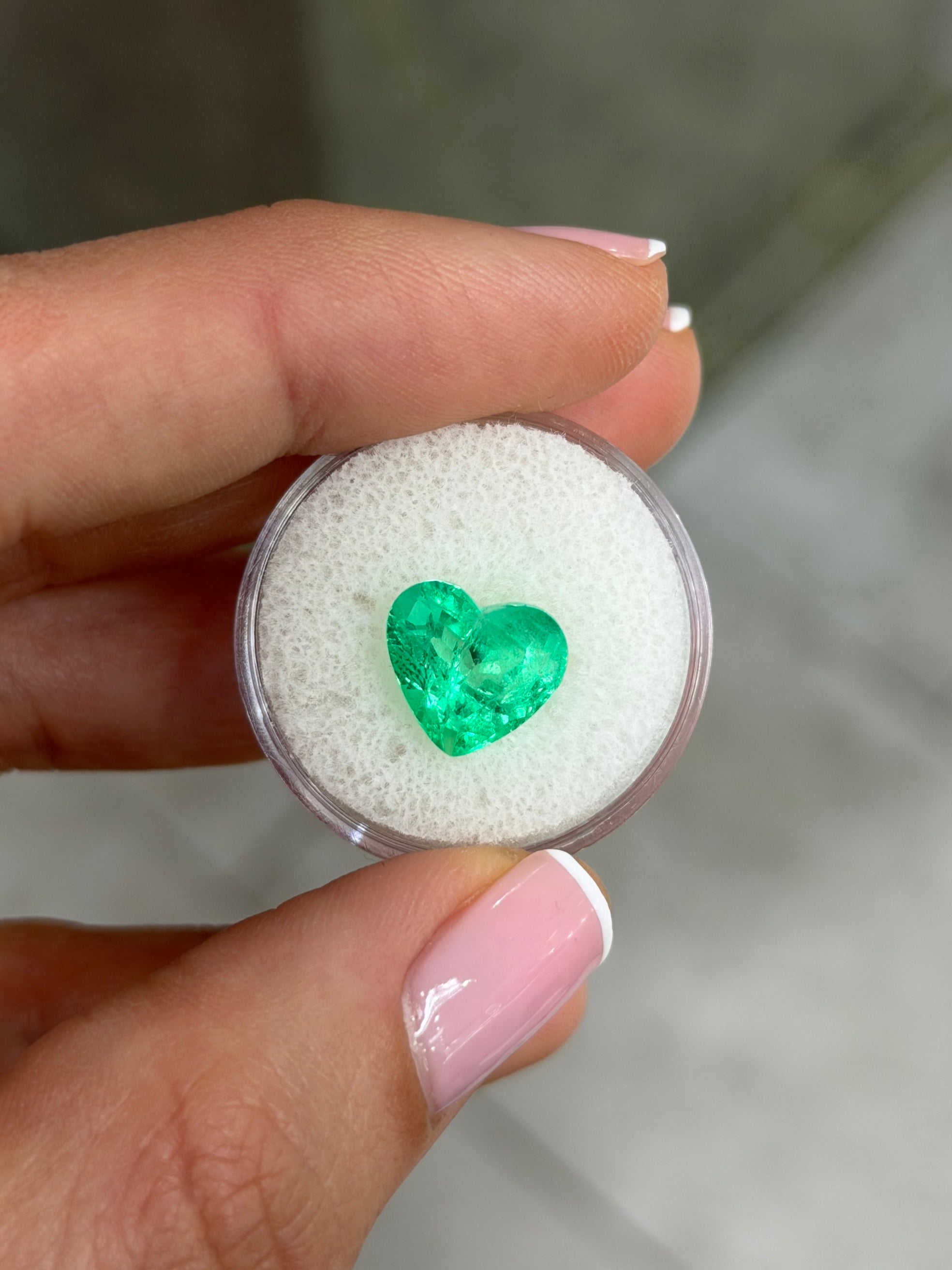 Natural loose Colombian emerald, 4.83 carats, 10x11mm heart cut, glowing electric green from JR Colombian Emeralds.