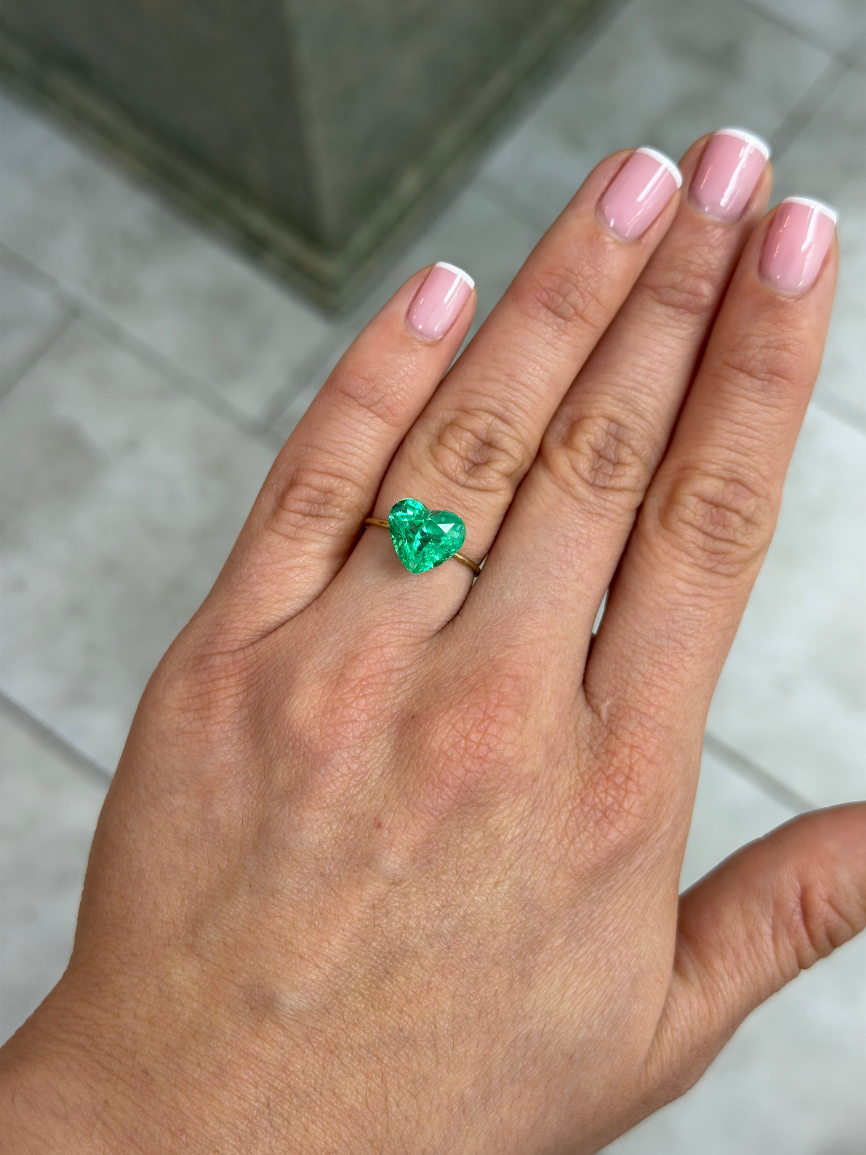 Natural loose Colombian emerald heart cut, 4.83 carats, glowing electric green, from JR Colombian Emeralds.