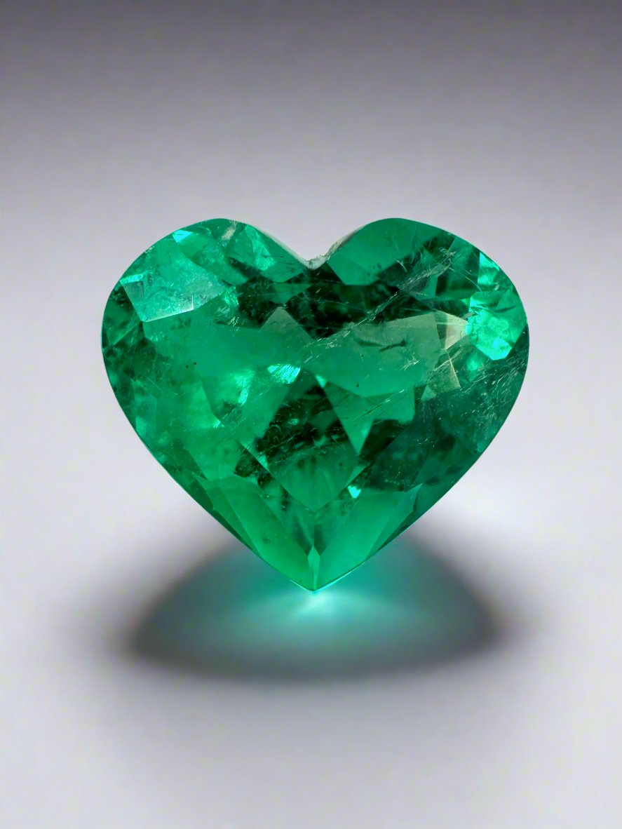 Vivid green 4.92 carat Colombian emerald loose heart-cut gemstone from JR Colombian Emeralds on a white background.