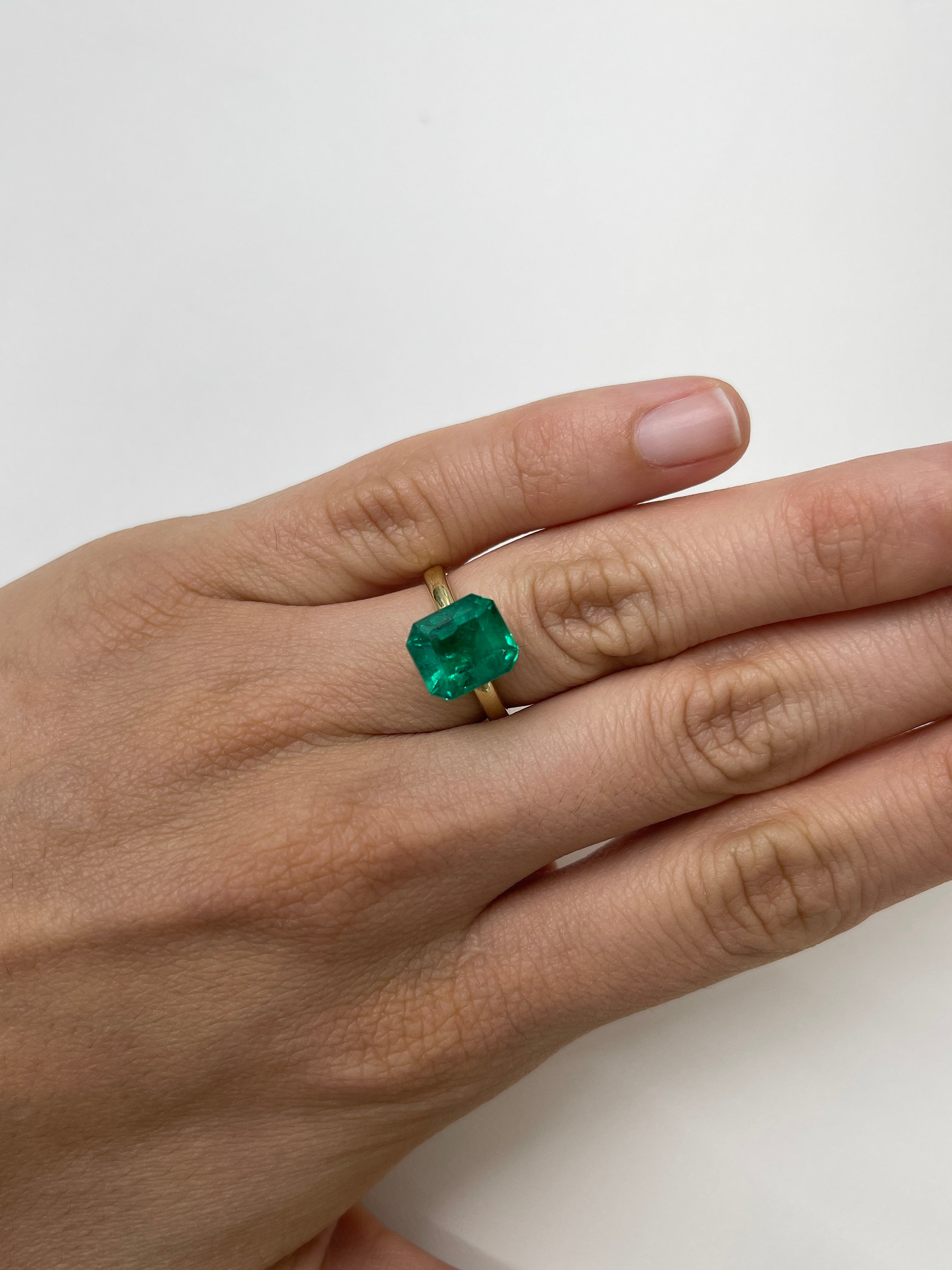 Natural 4.93 Carat Colombian emerald cut loose gemstone from JR Colombian Emeralds, AAA+ investment grade, vivid green color.