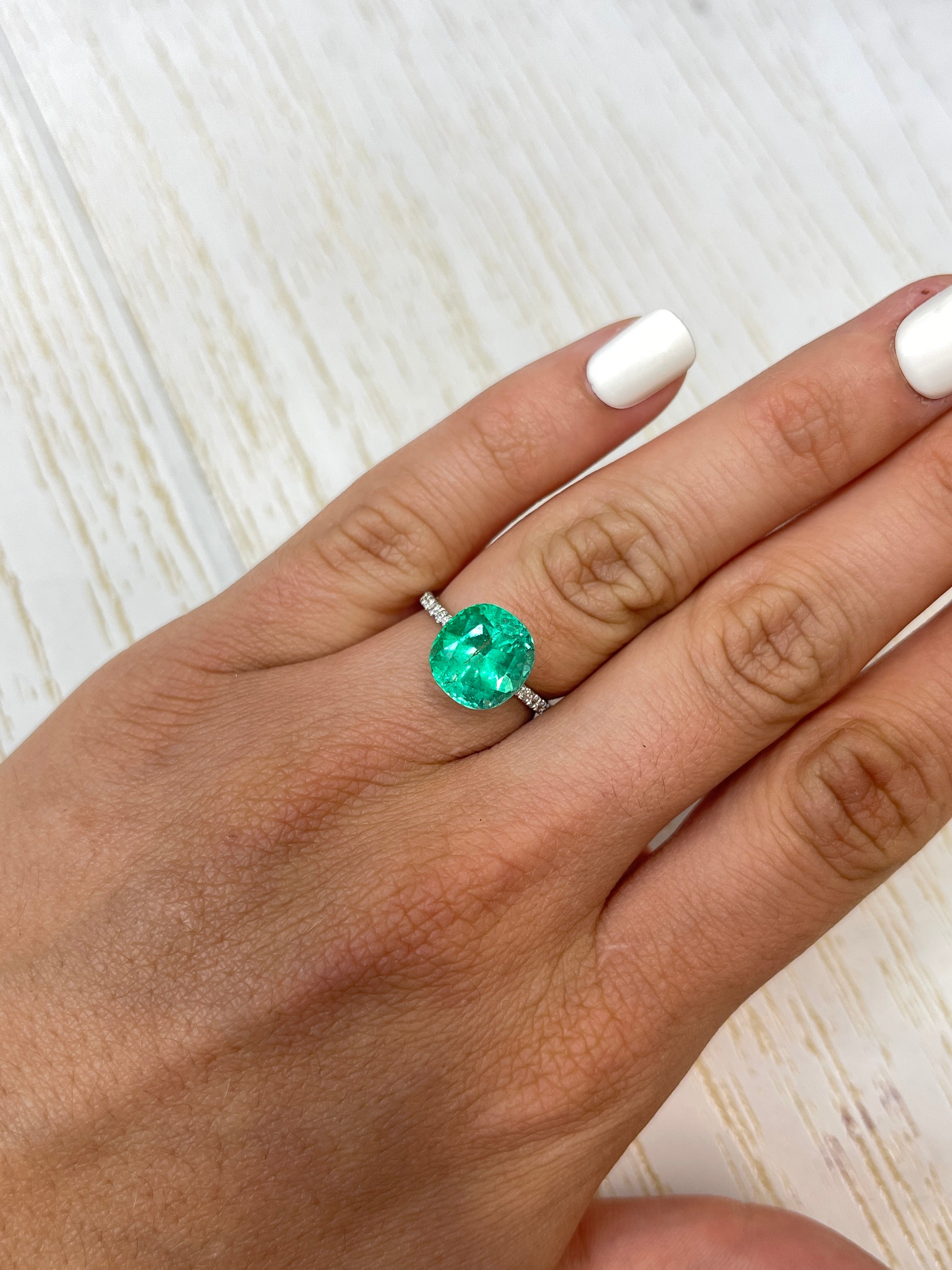 4.94 carat natural green Colombian emerald loose cushion cut gemstone, showcasing vibrant color and clarity.