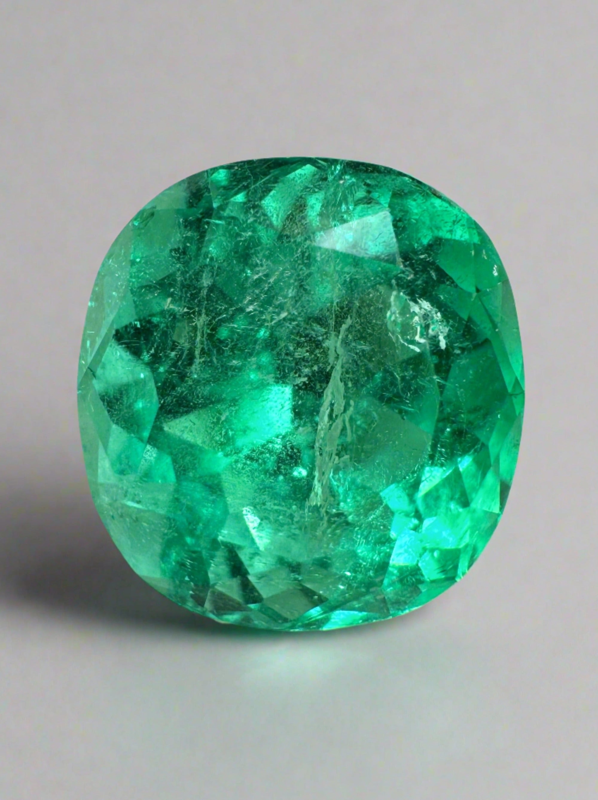 4.94 carat natural green Colombian emerald loose cushion cut gemstone from JR Colombian Emeralds on a white background.