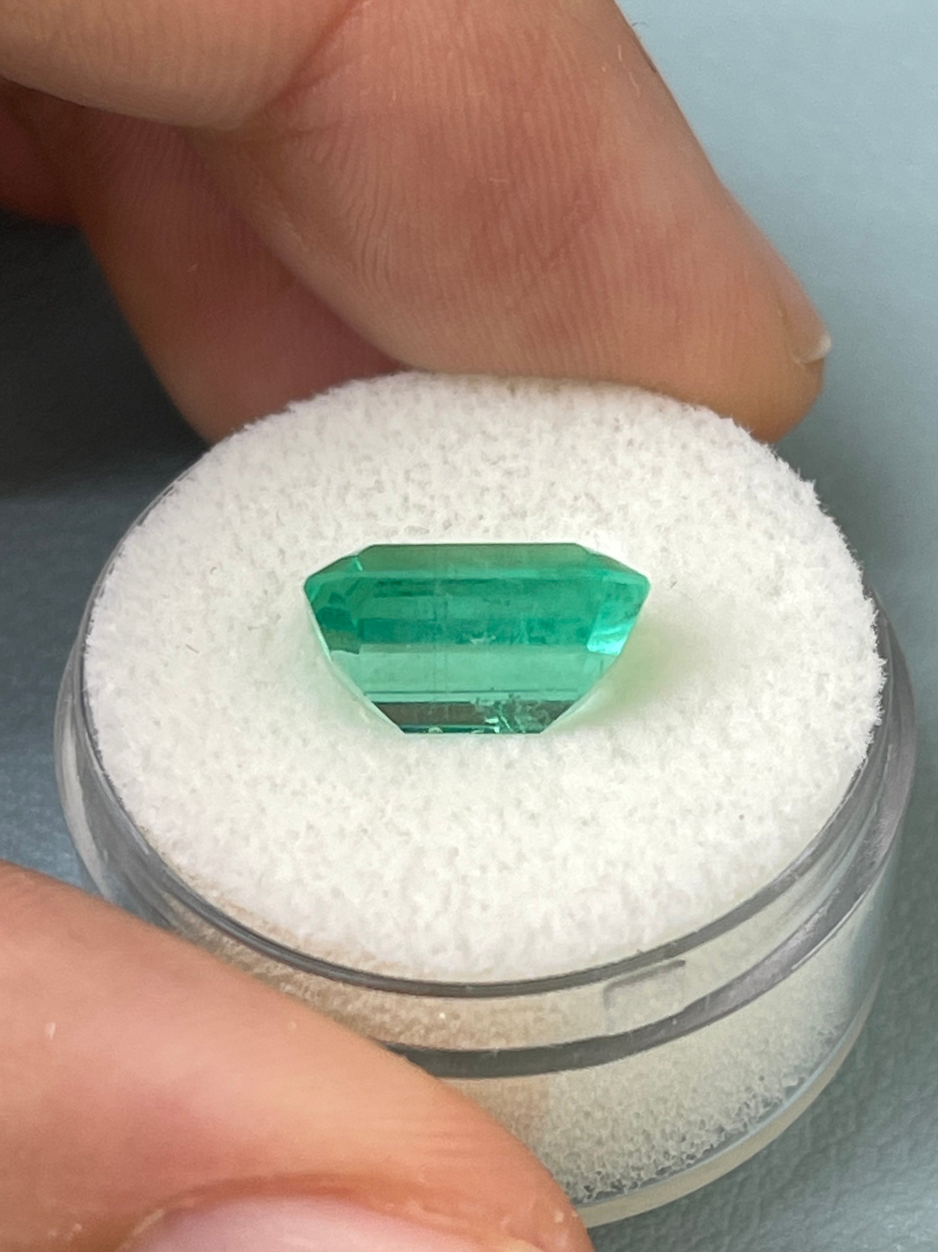 Loose 5.02 carat Colombian emerald in classic emerald cut, crystalline and natural with vibrant green color.
