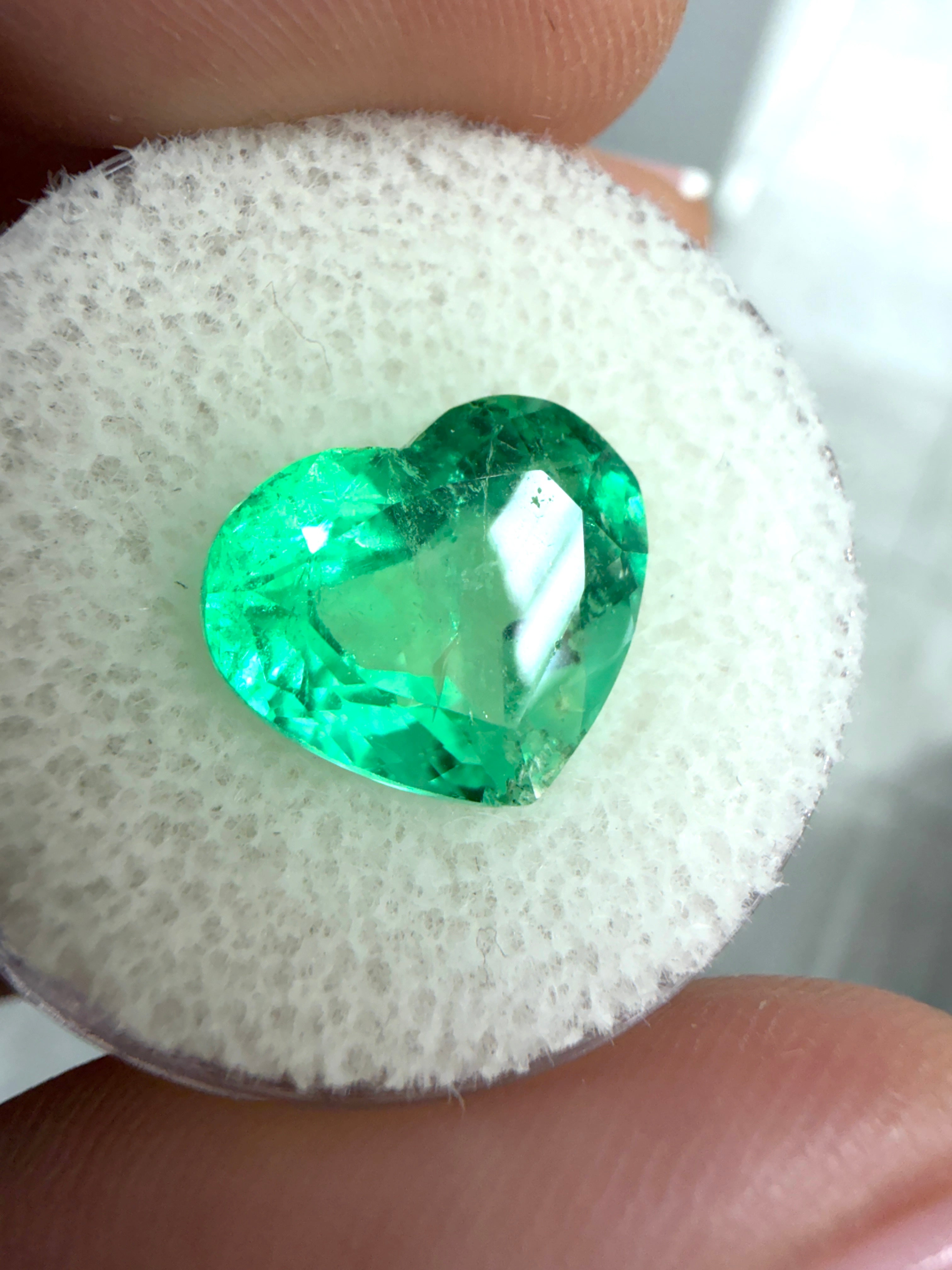 Natural green Colombian emerald, 5.19 carats, 10x12mm heart cut, loose gemstone with vibrant electric green color.