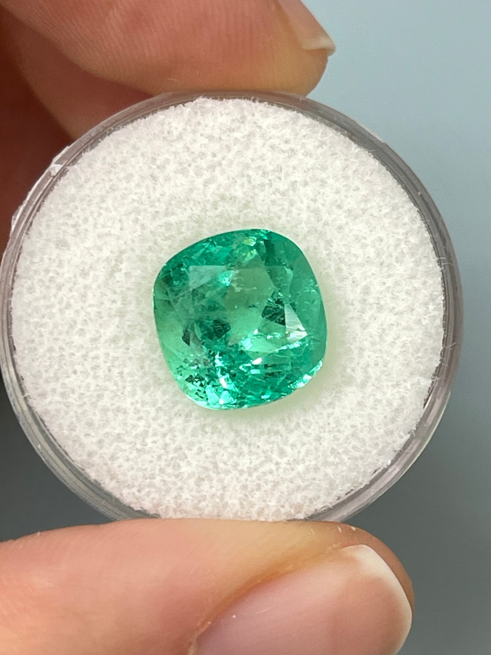 Bright bluish green 5.20 carat natural Colombian emerald loose cushion cut gemstone from JR Colombian Emeralds.