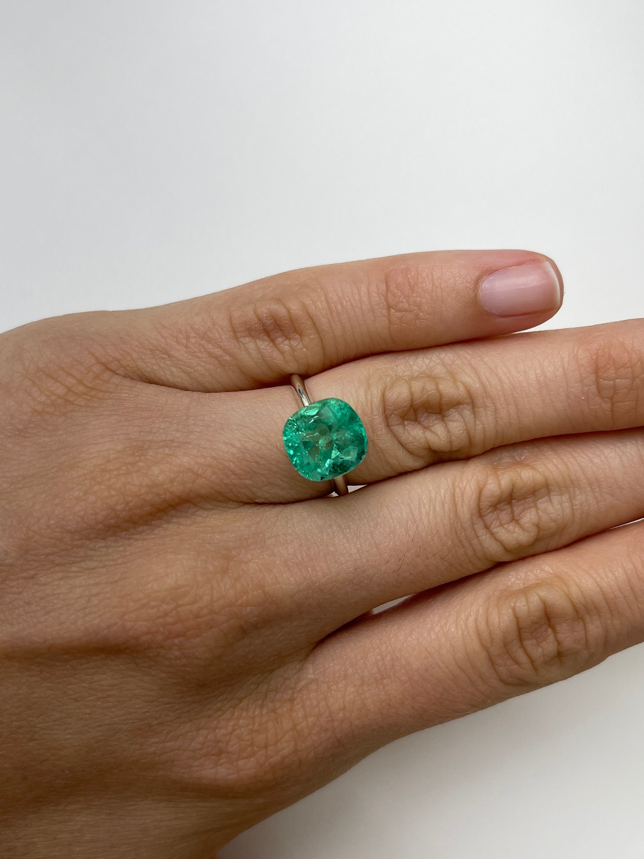 Bright bluish green 5.20 carat natural Colombian emerald in cushion cut, loose gemstone from JR Colombian Emeralds.