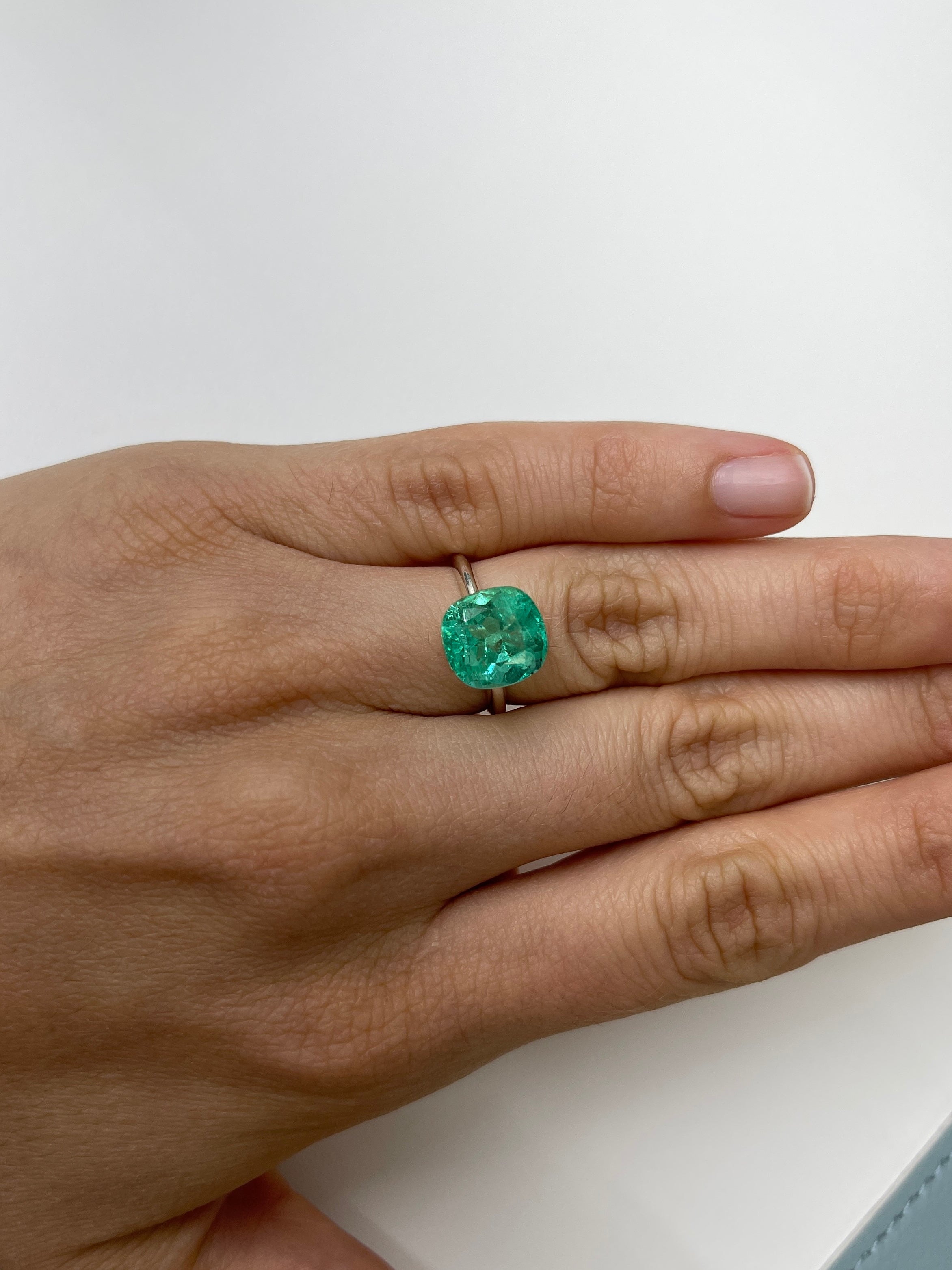 Bright bluish green 5.20 carat natural Colombian emerald in cushion cut, loose gemstone from JR Colombian Emeralds.