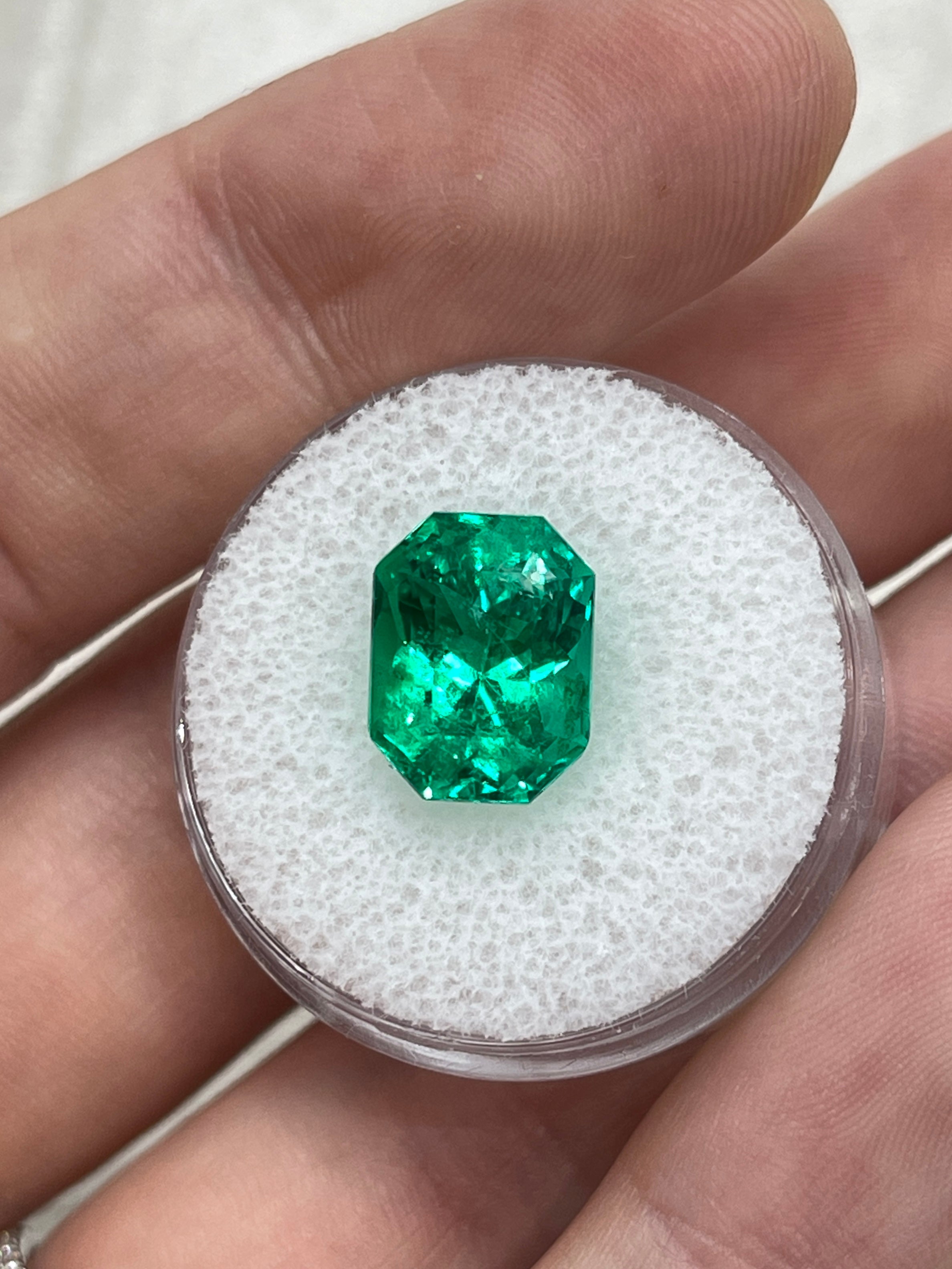 Vivid bluish green 5.21-carat Colombian emerald cut emerald with clipped corners, showcasing clarity and rich color from JR Colombian Emeralds.