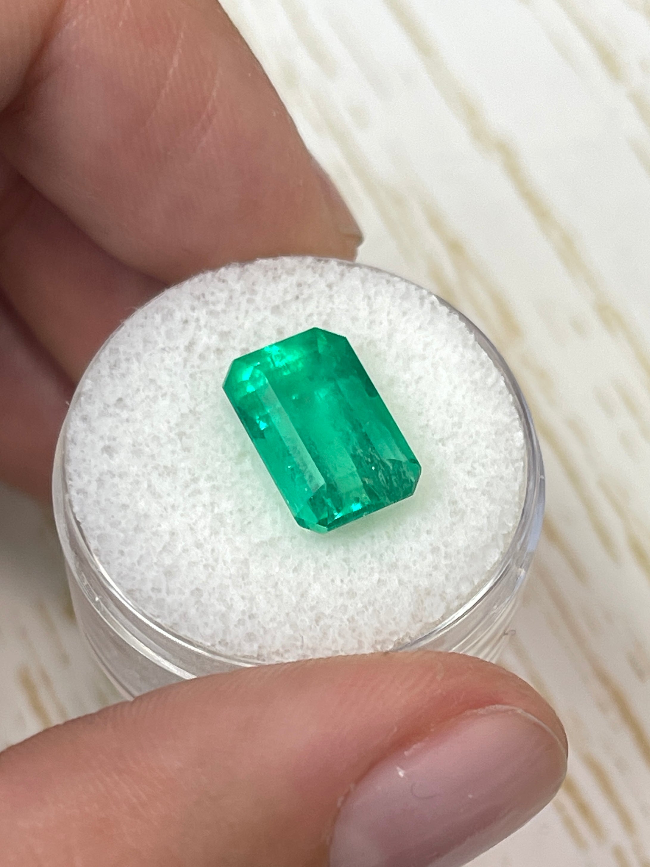 Yellowish green 5.26 carat natural Colombian emerald loose gemstone in an emerald cut, showcased by JR Colombian Emeralds.