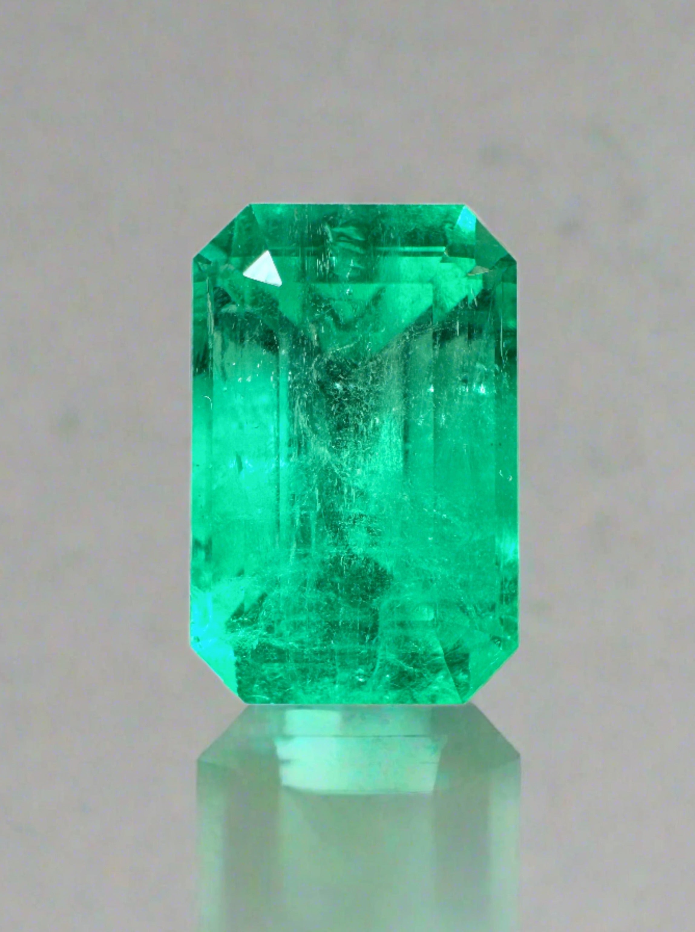 Yellowish green 5.26 carat natural Colombian emerald in an emerald cut, showcasing clarity and vibrant color.