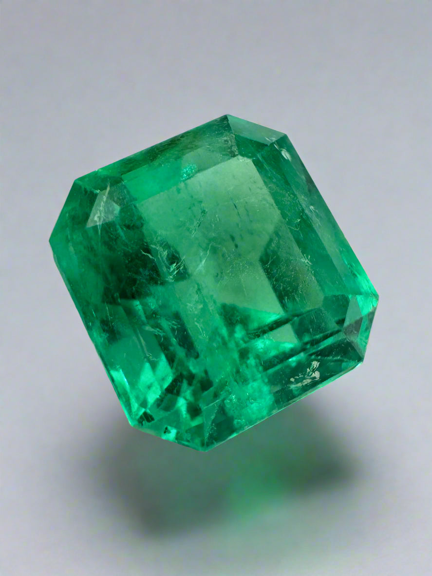 Vibrant 5.29 carat loose Colombian emerald in a 10.5x10mm Asscher cut, displayed in a jewelry setting.