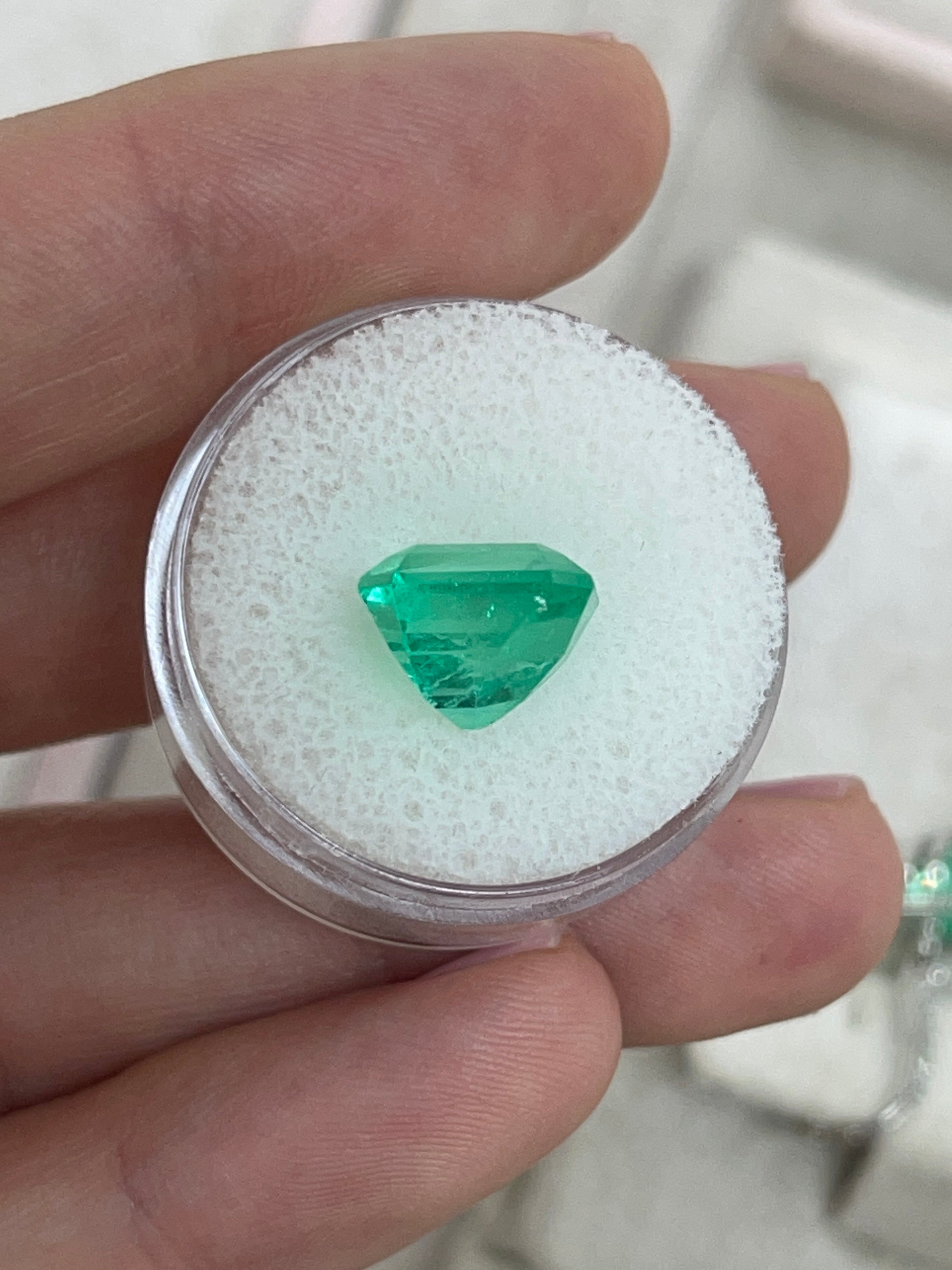 Vibrant 5.29 carat Colombian emerald loose gemstone in Asscher cut, showcasing rich green color and clarity.