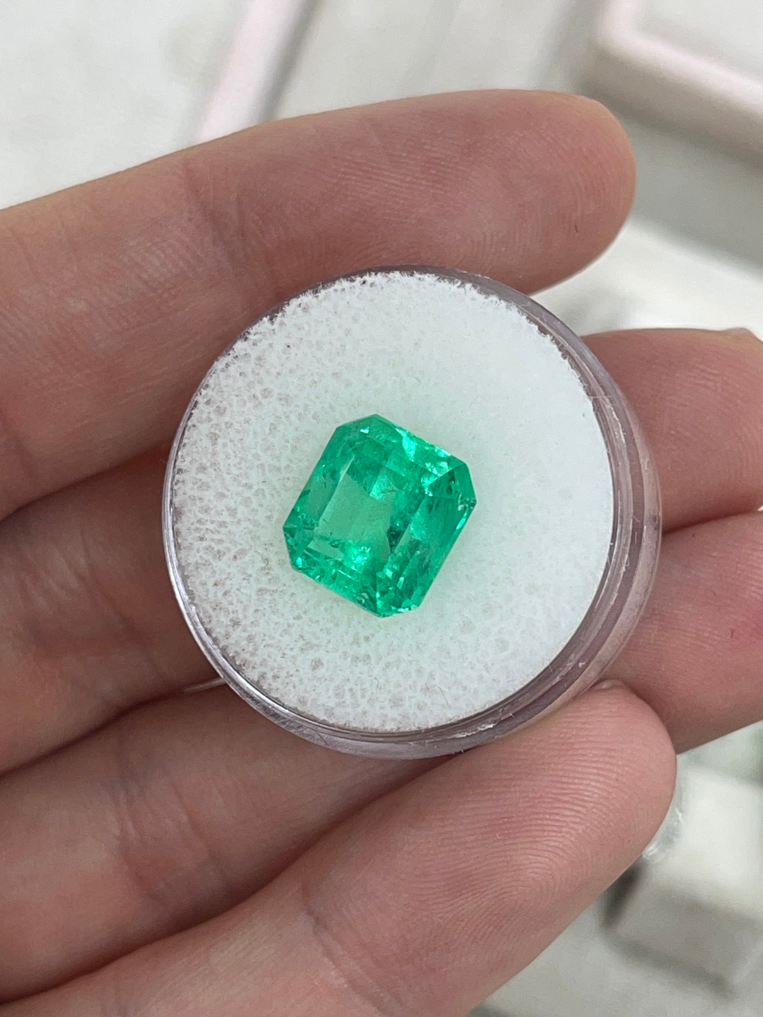 Vibrant 5.29 carat loose Colombian emerald in Asscher cut with 10.5x10mm dimensions, from JR Colombian Emeralds.
