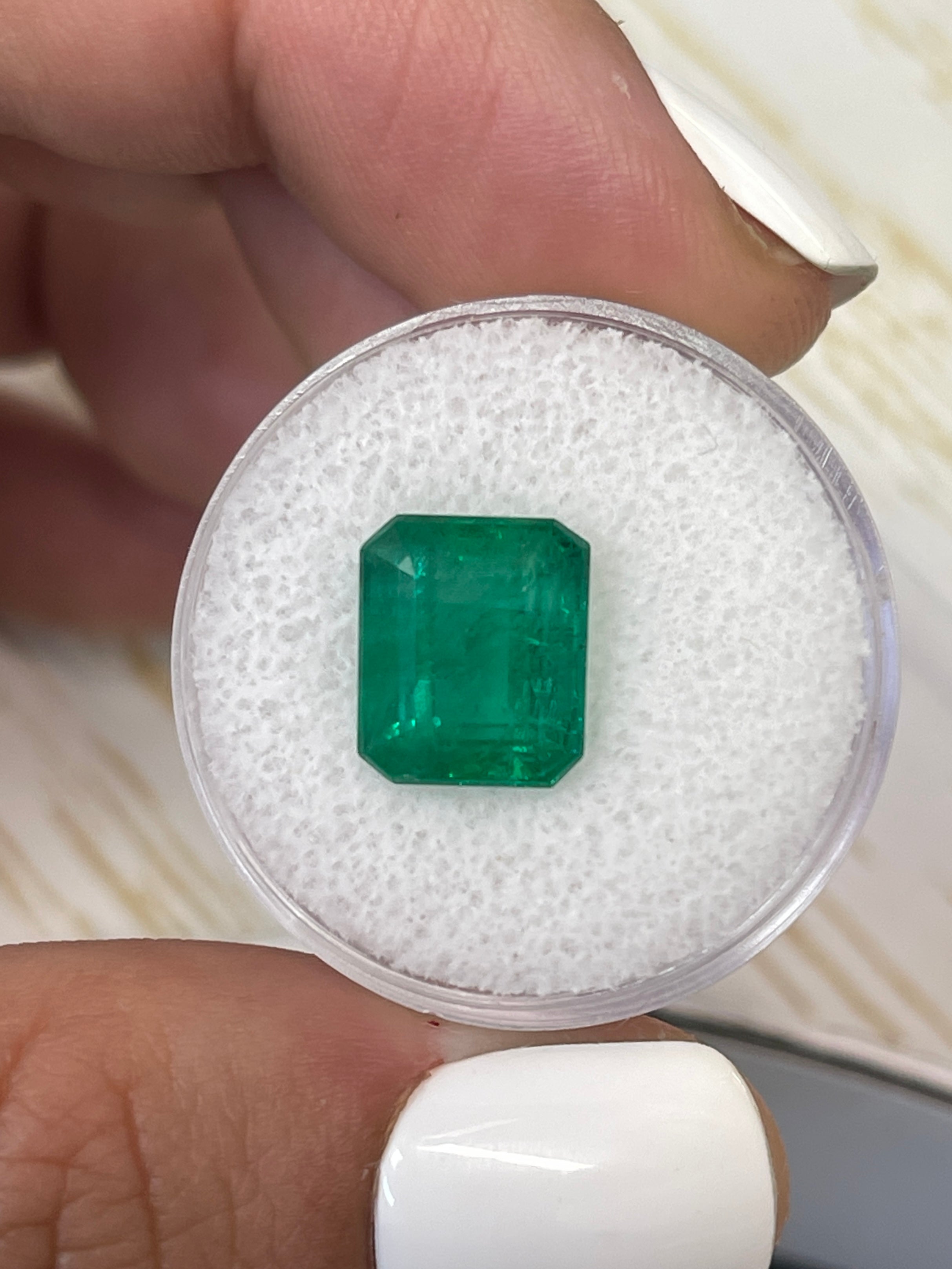 5.32 carat natural Zambian emerald cut loose gemstone in vivid Kelly green, from JR Colombian Emeralds.