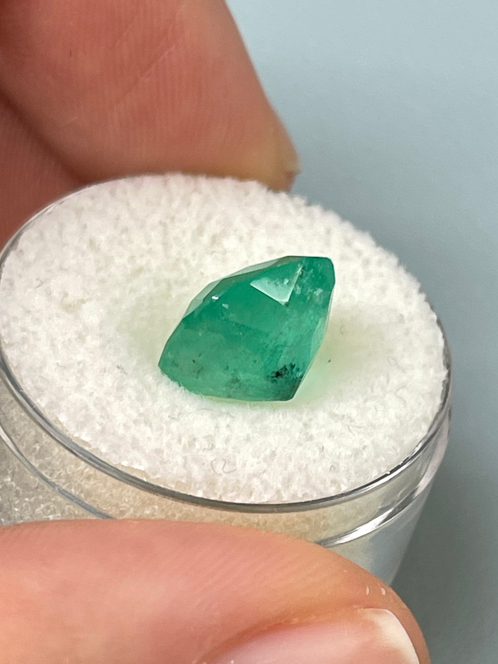 5.33 carat earthy natural loose Colombian emerald in cushion cut, showcasing rich green color and clarity.