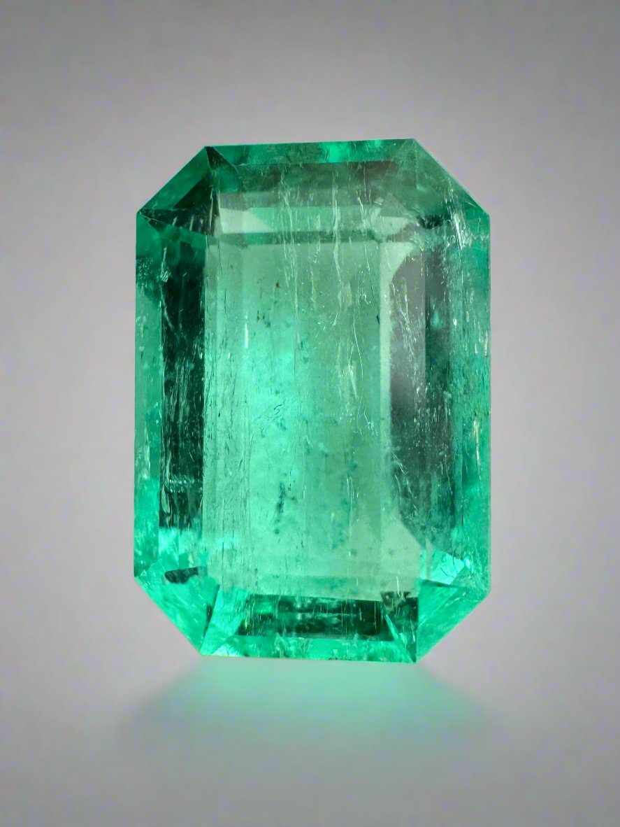 Bluish green 5.45 carat natural loose emerald cut gemstone from JR Colombian Emeralds, showcasing its vibrant color and clarity.