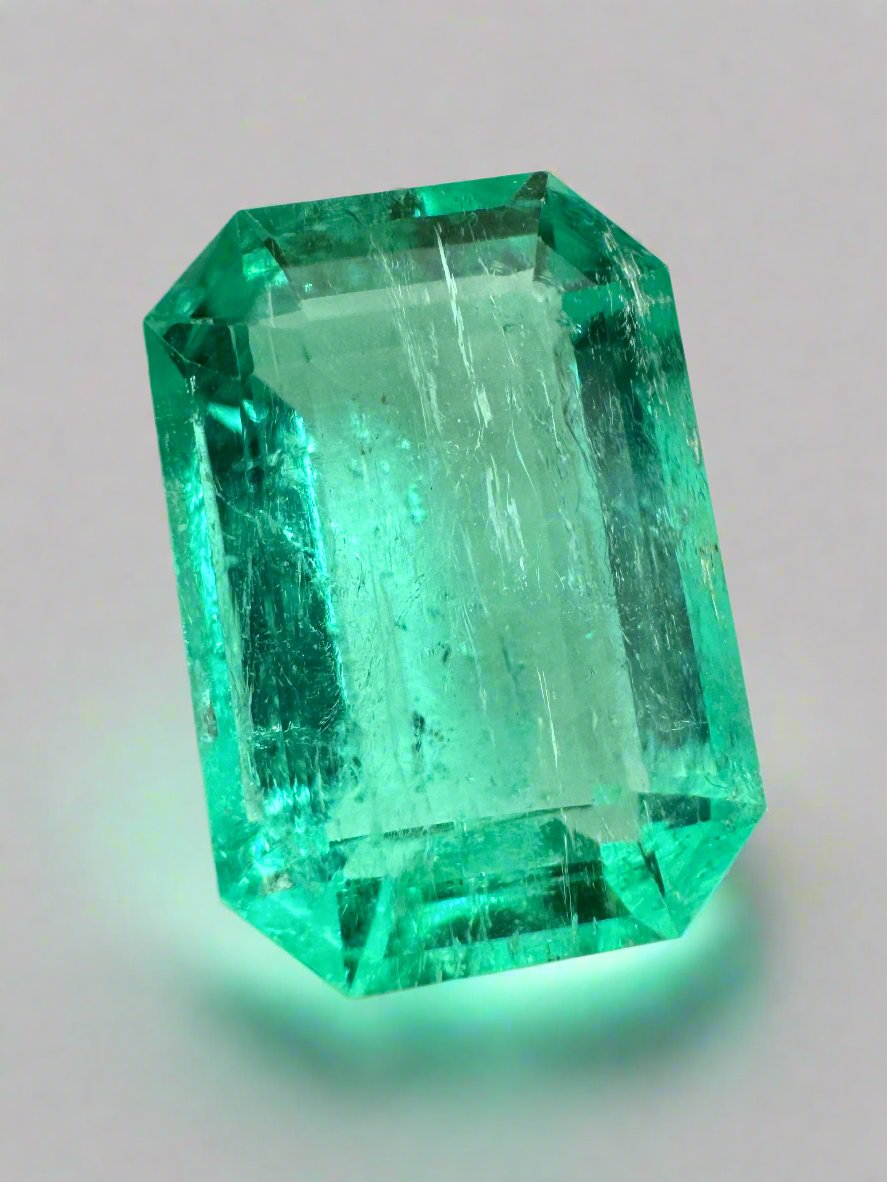 5.45 carat bluish green natural loose emerald cut gemstone from JR Colombian Emeralds, showing a clear emerald shape and vibrant color.