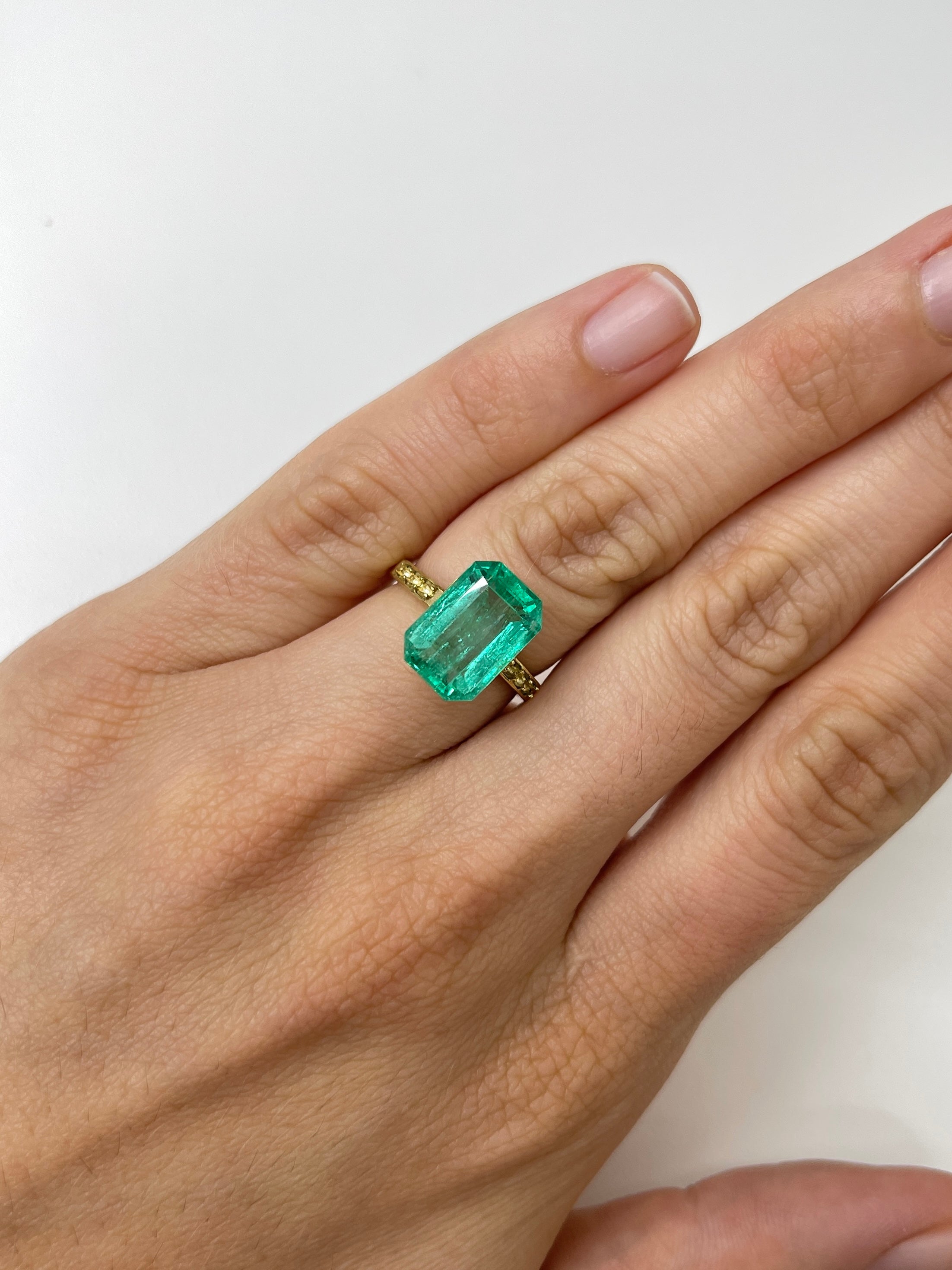 5.45 carat bluish green natural loose emerald cut gemstone from JR Colombian Emeralds, showing clarity and vibrant color.