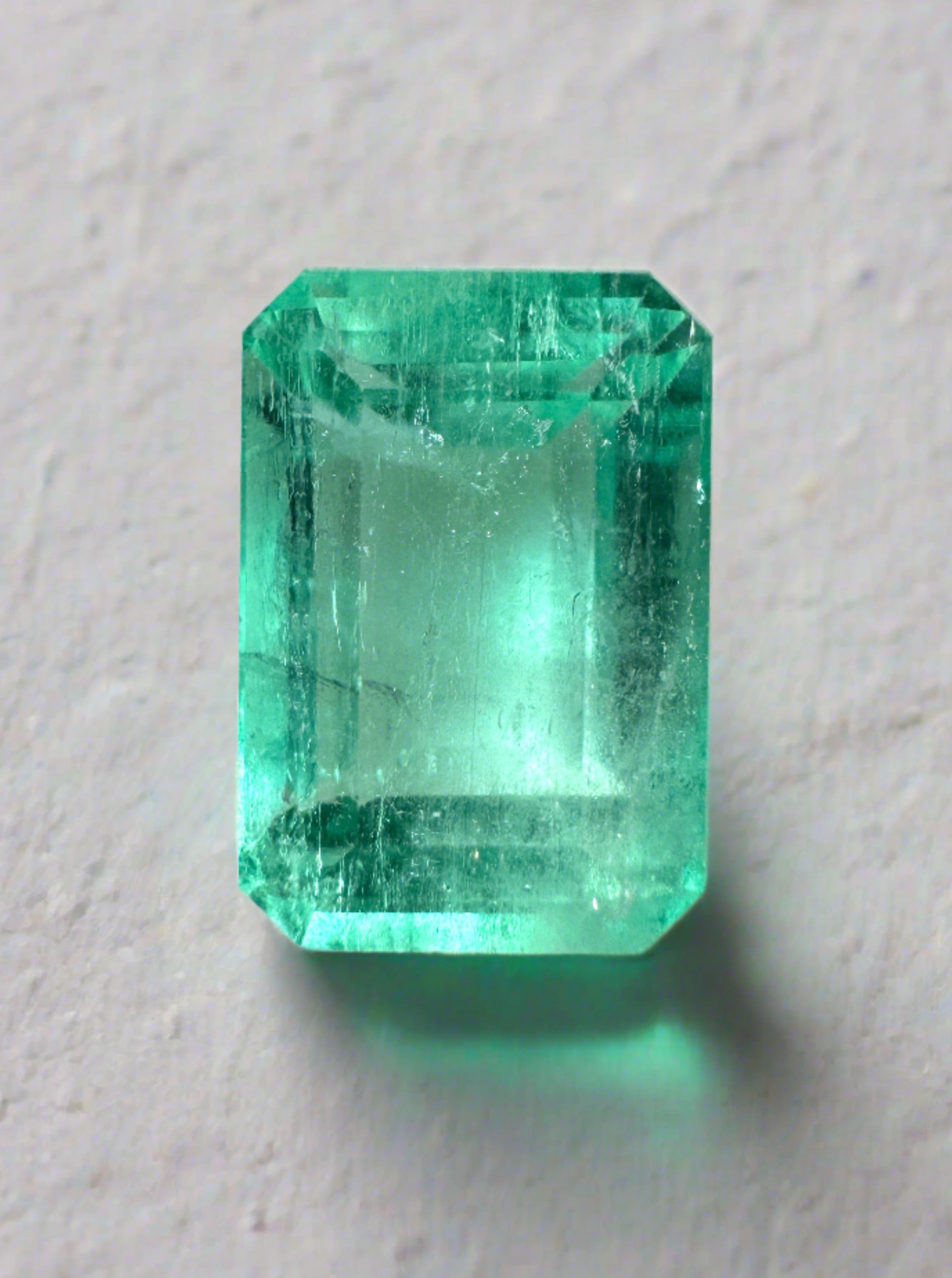 5.55 carat pastel green Colombian emerald loose gemstone in an emerald cut, showcasing natural color and clarity.