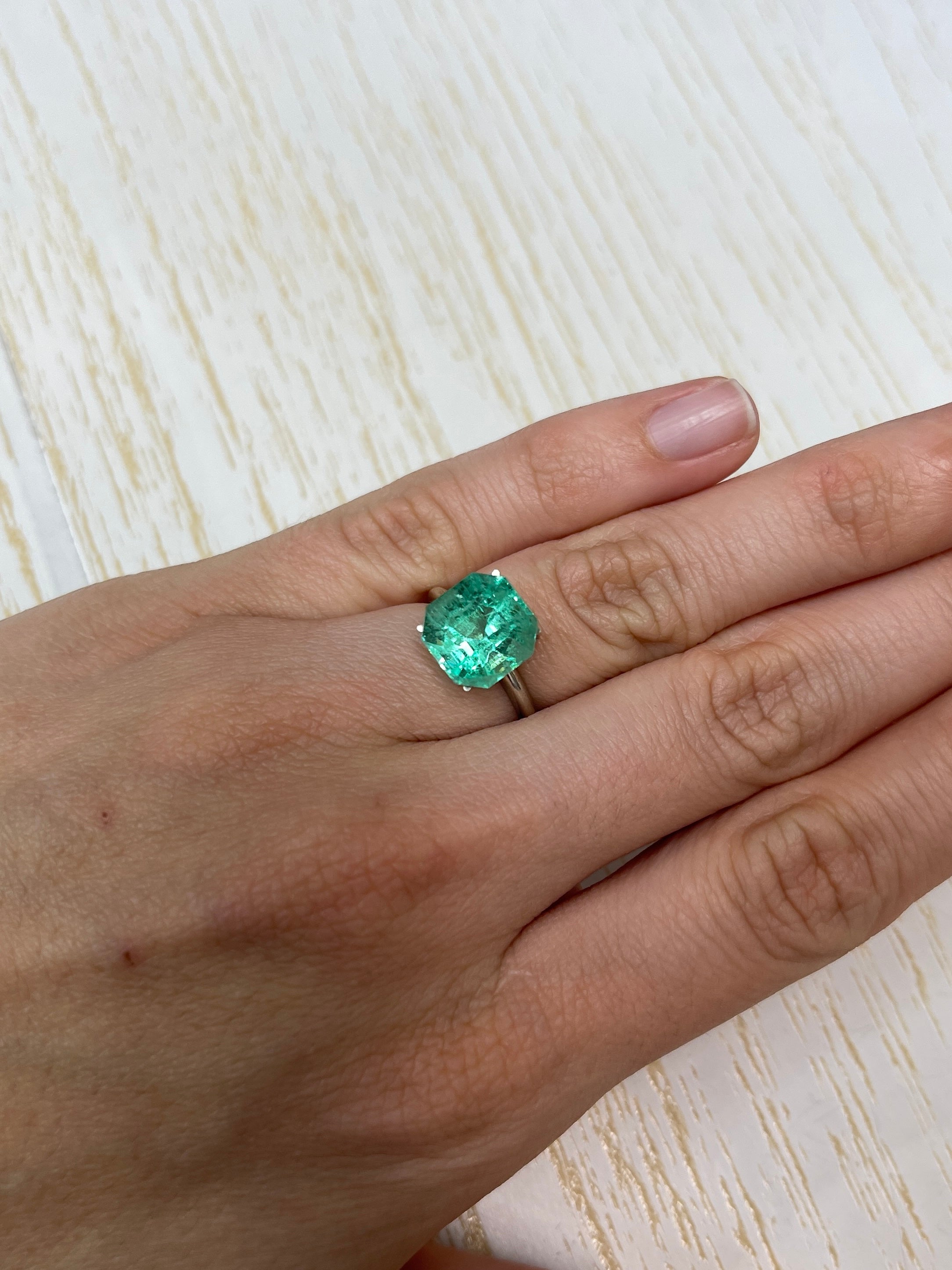 Spring green 5.56 carat natural Colombian emerald loose gemstone in Asscher cut, showcasing vibrant color and clarity.