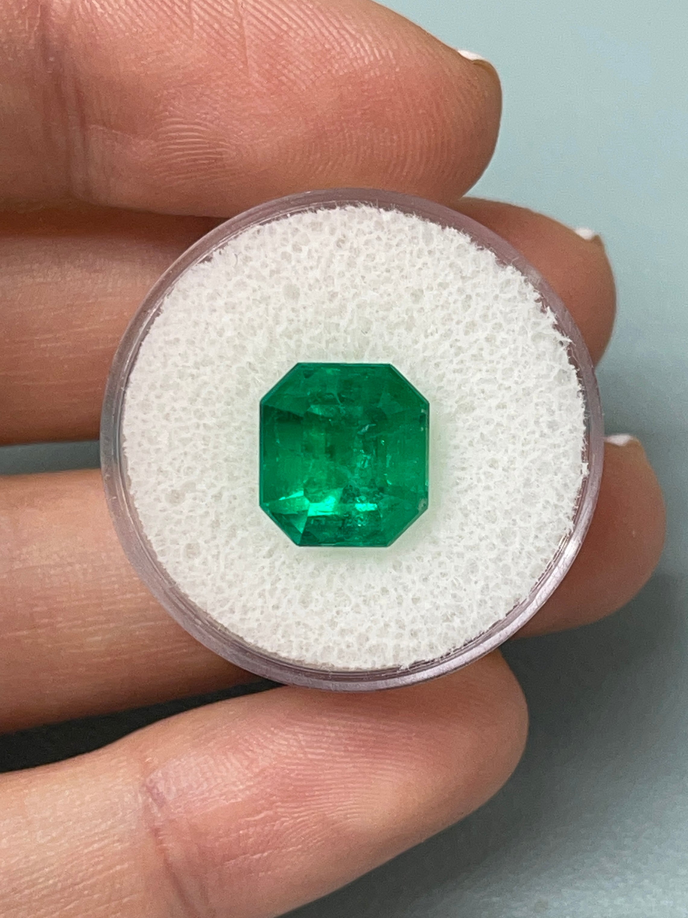 5.56 carat AAA Vivid Muzo Colombian emerald loose stone with emerald cut, showcasing rich green color and natural clarity.