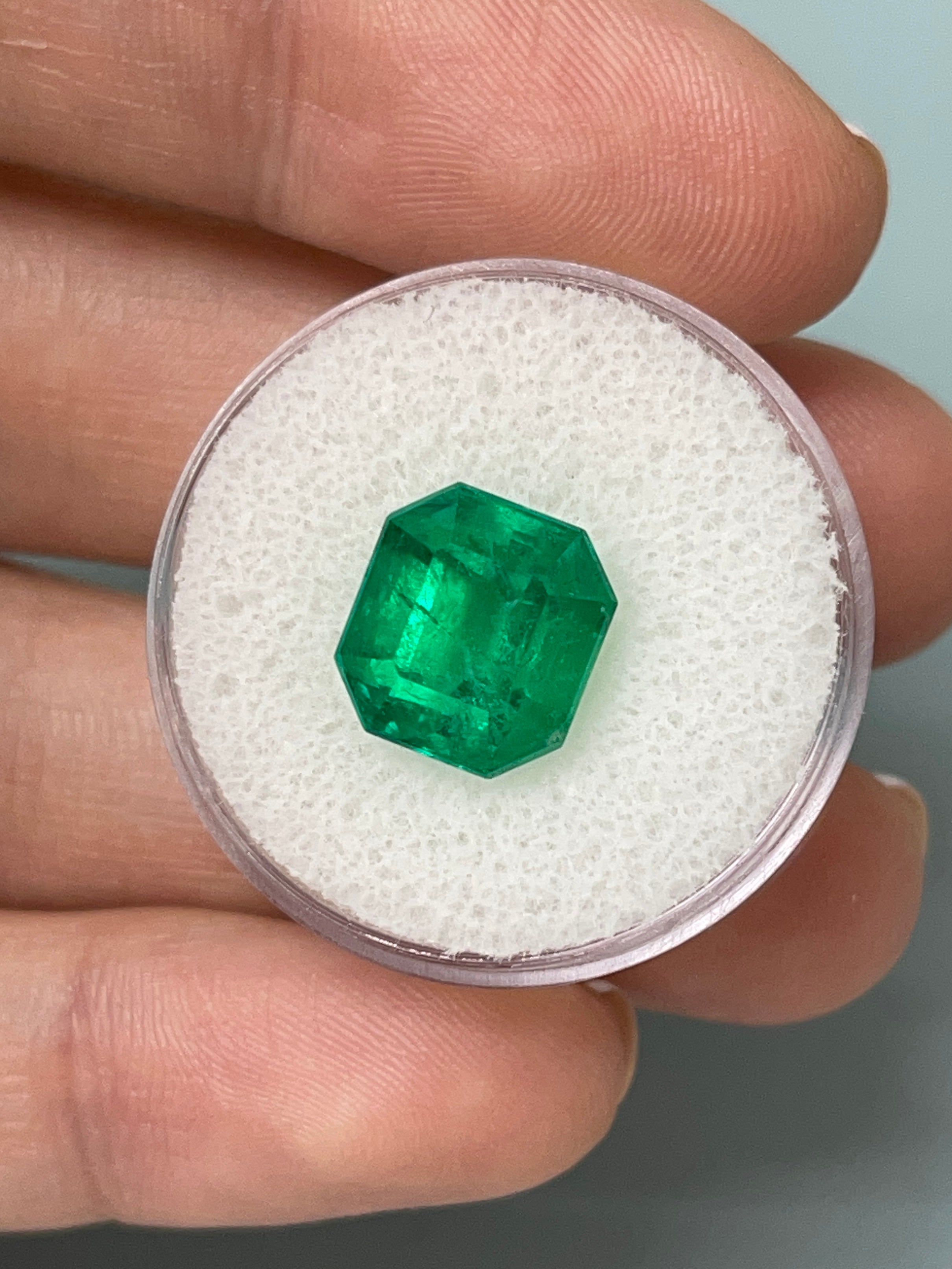 Loose 5.56 carat AAA Vivid Muzo Colombian Emerald in an emerald cut, showcasing its vibrant green color and natural clarity.