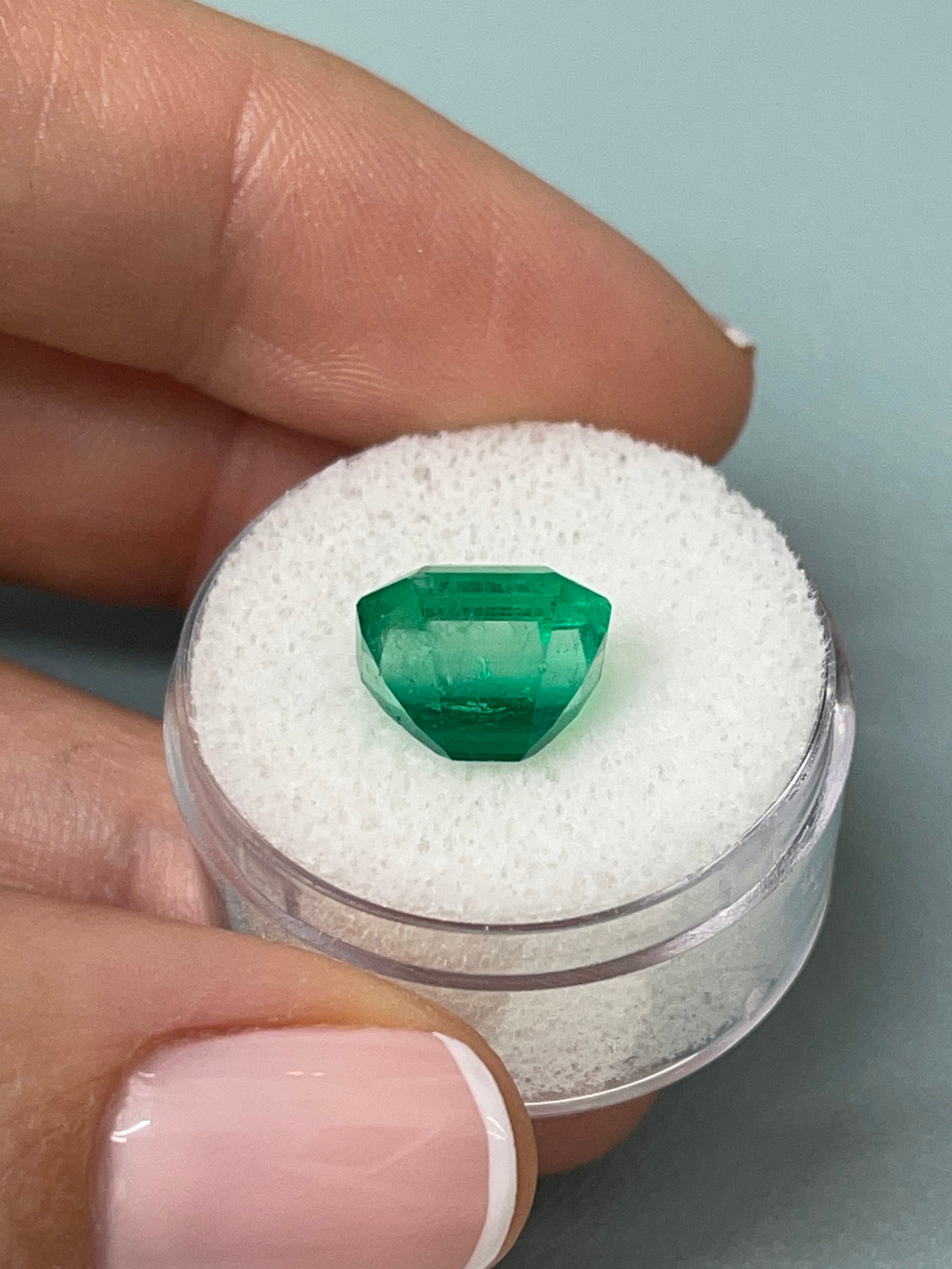 5.56 carat AAA Vivid Muzo Colombian Emerald loose gemstone in emerald cut, showcasing deep green color and clarity.