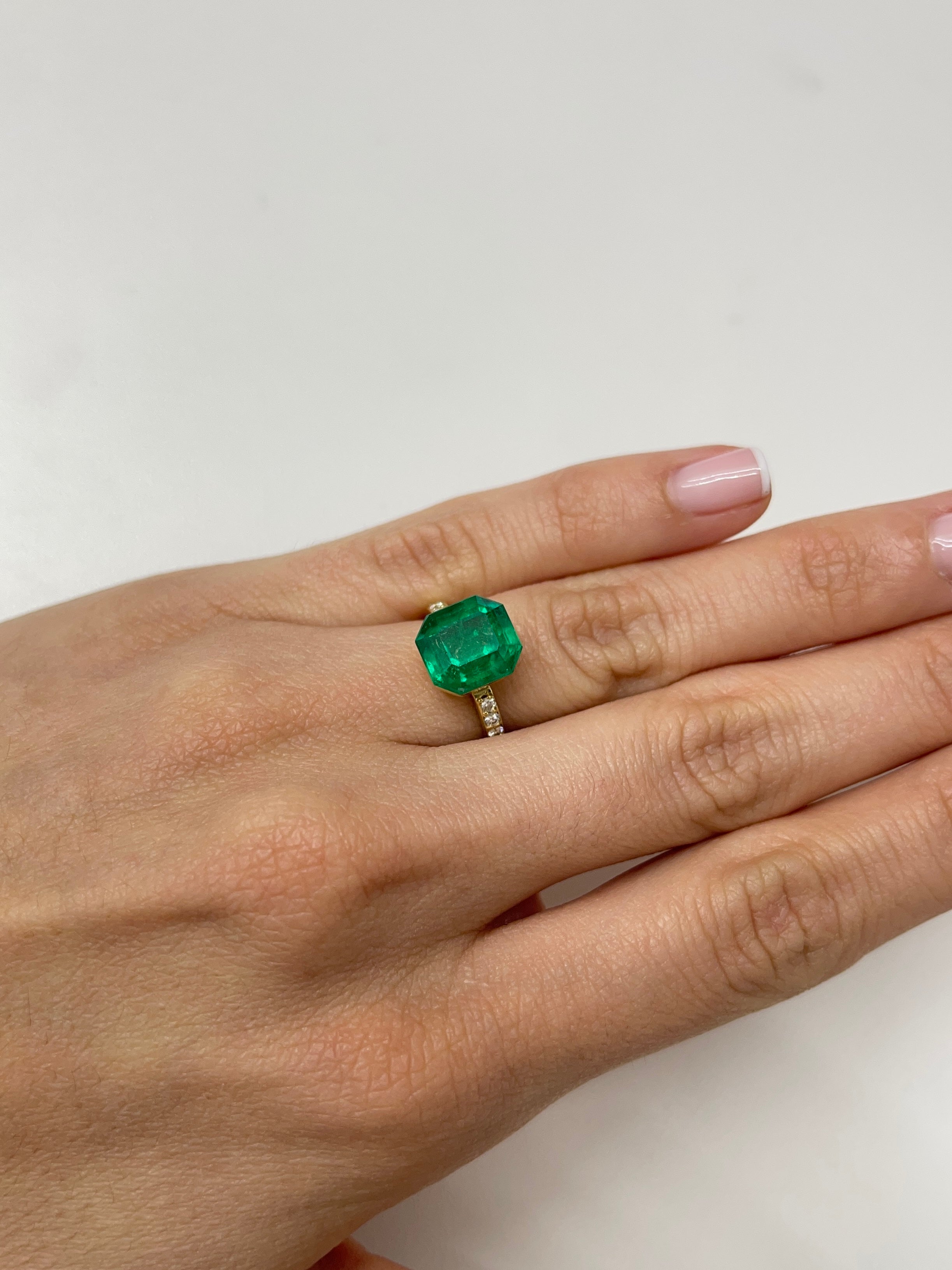 5.56 carat AAA Vivid Muzo Colombian emerald loose gemstone with emerald cut, showcasing rich green color and clarity.