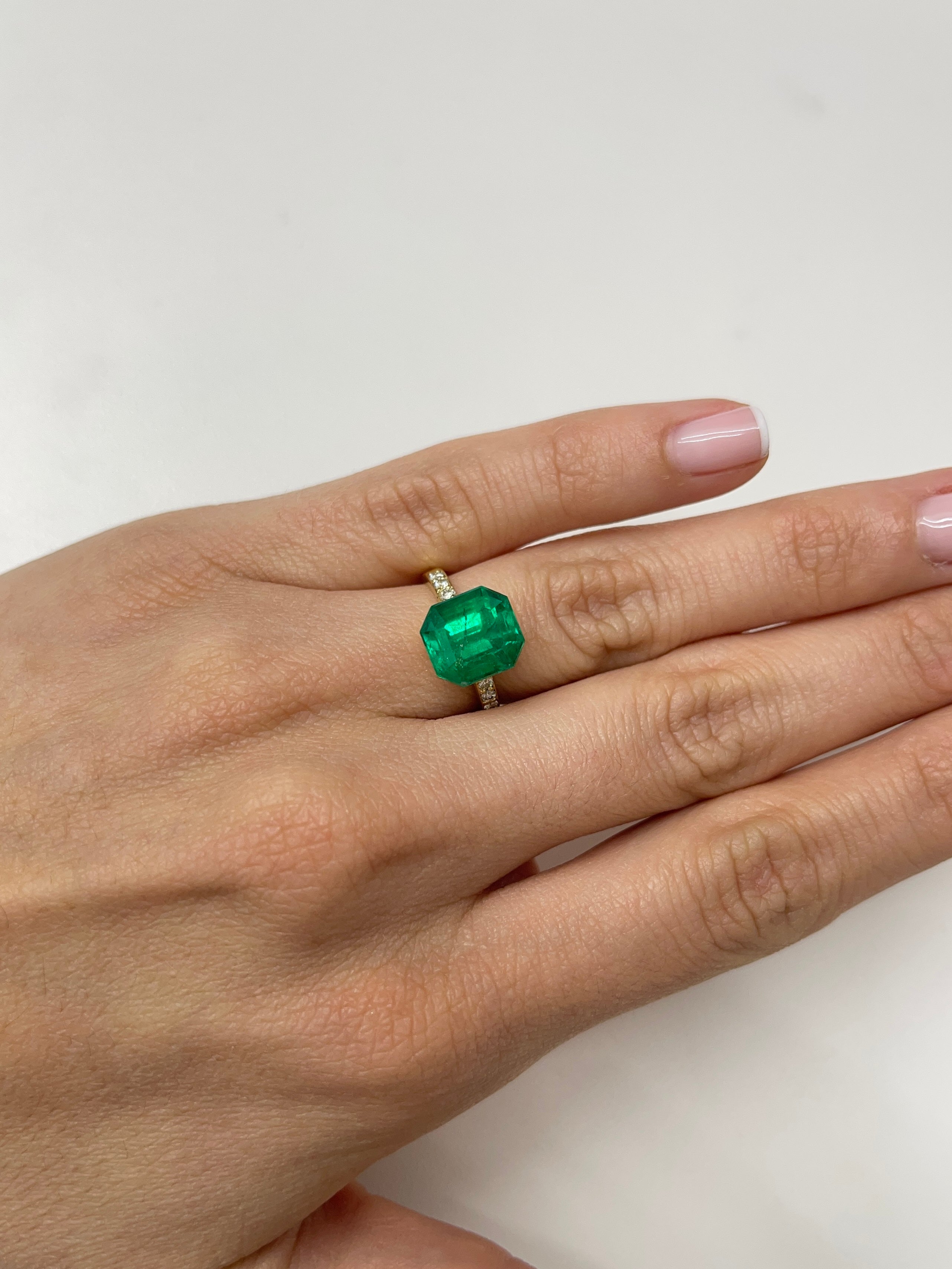 5.56 carat AAA Vivid Muzo Colombian emerald loose stone in an emerald cut, showcasing rich green color and natural clarity.