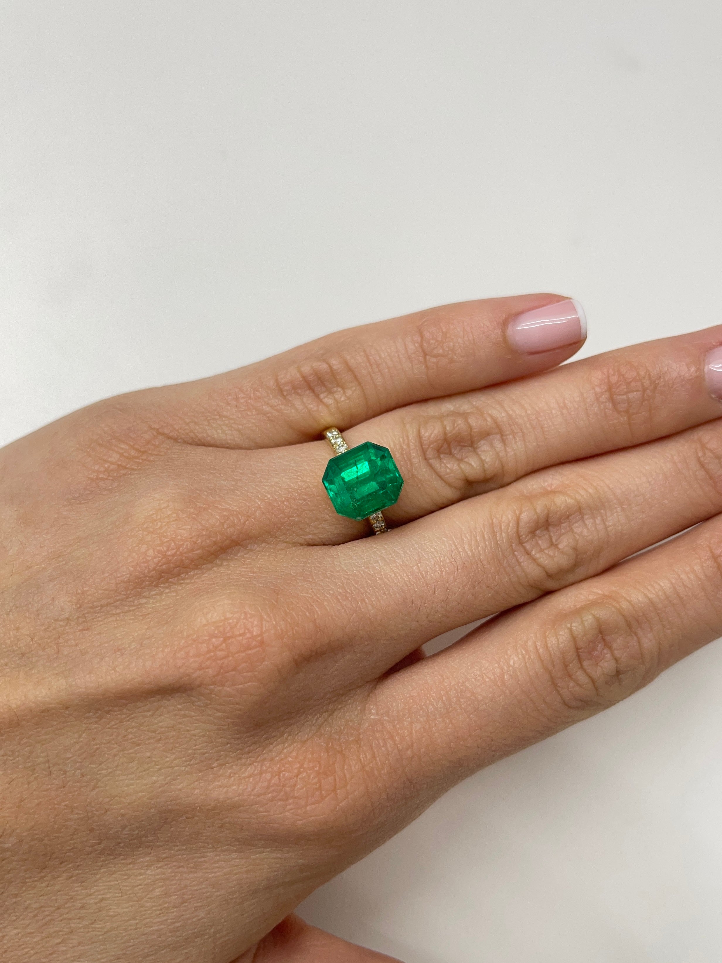 5.56 carat AAA Vivid Muzo Colombian emerald loose gemstone with emerald cut, showcasing rich green color and natural clarity.
