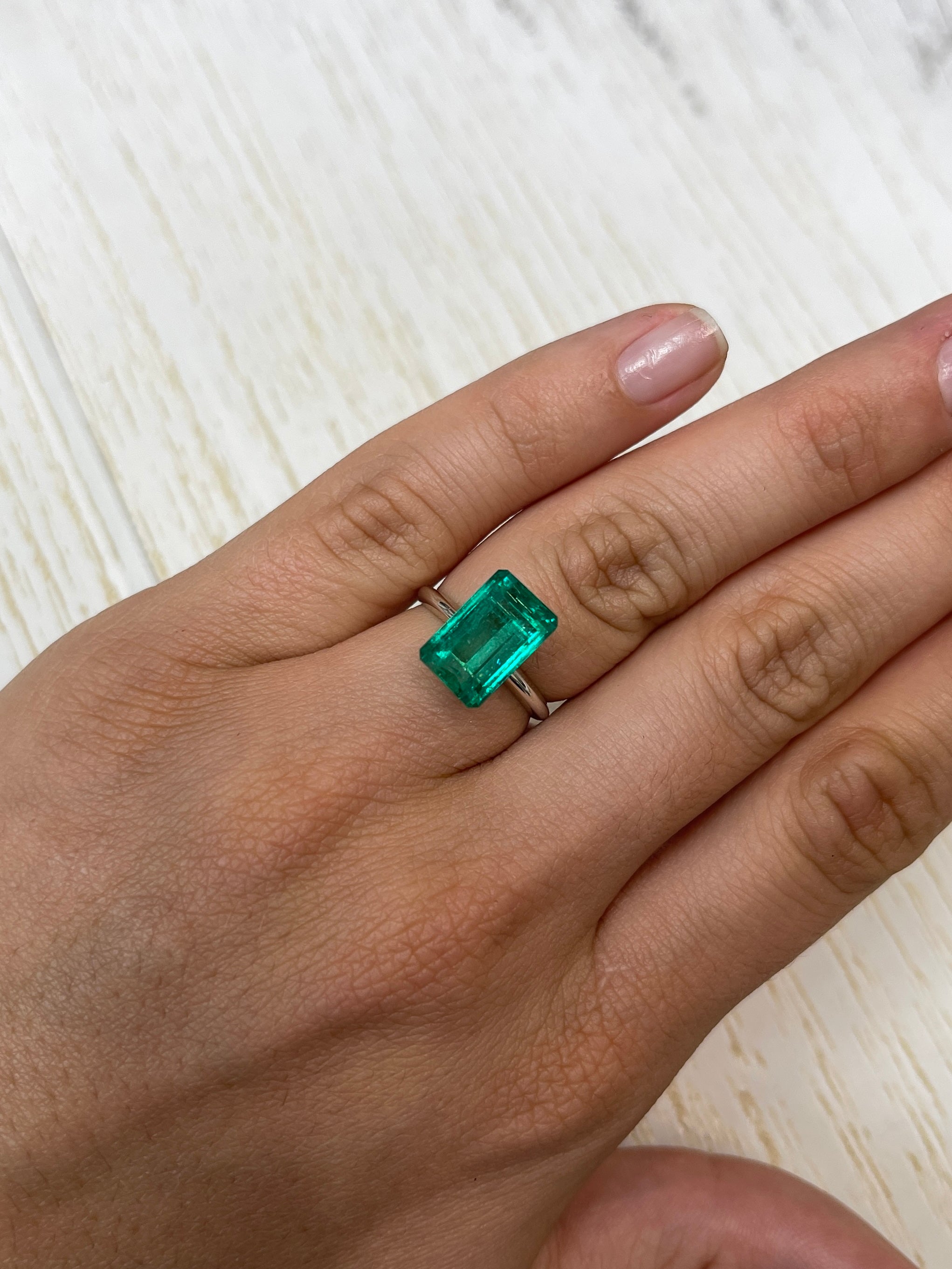 5.63 Carat 13x8mm VS bluish green natural Colombian emerald loose gemstone in emerald cut, from JR Colombian Emeralds.