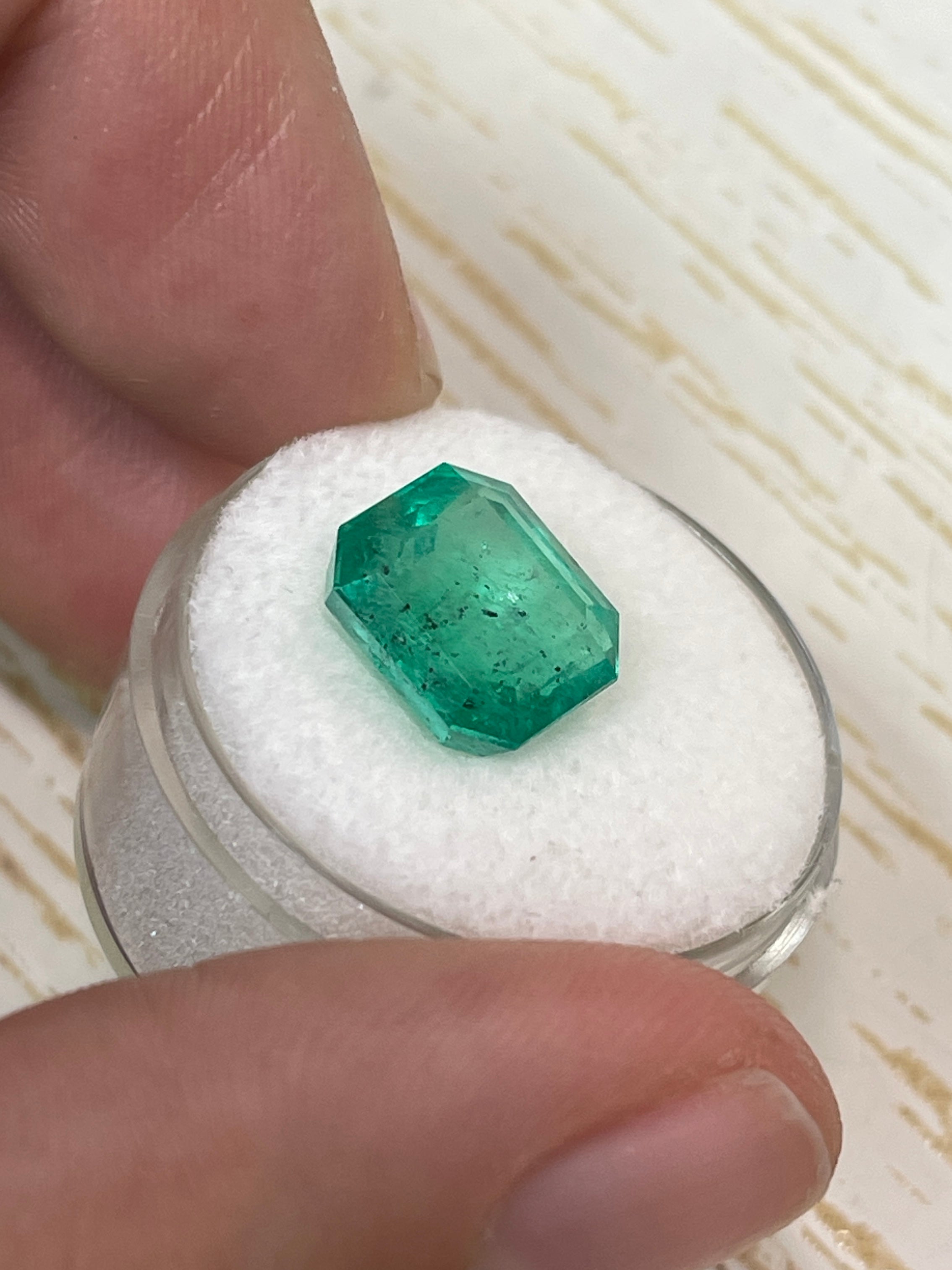 Natural 5.72 carat Colombian emerald loose gemstone, 11x10.5mm Asscher cut with natural freckles, from JR Colombian Emeralds.