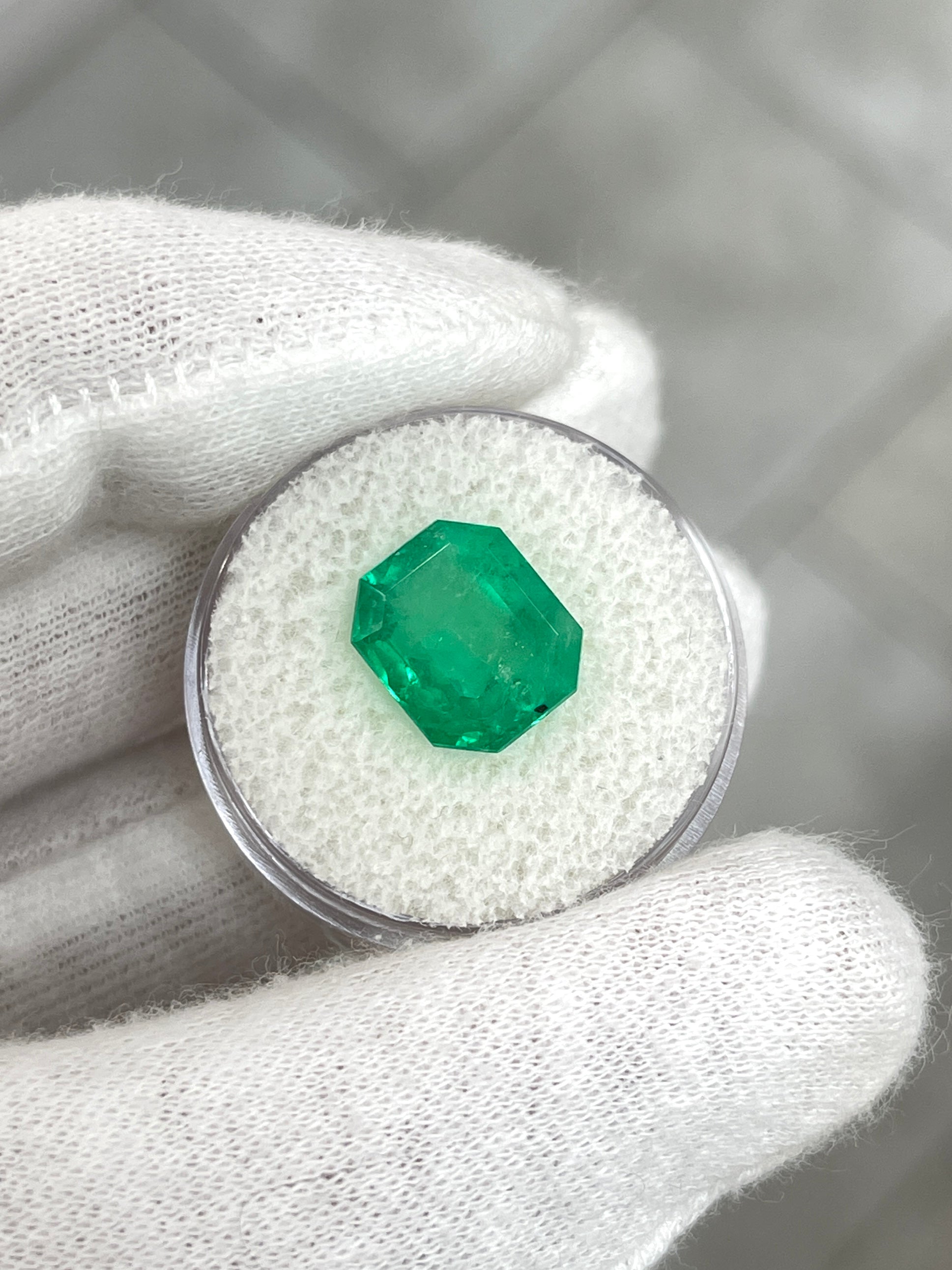 Medium green 5.75 carat Colombian emerald loose gemstone in emerald cut with natural freckled appearance, from JR Colombian Emeralds.